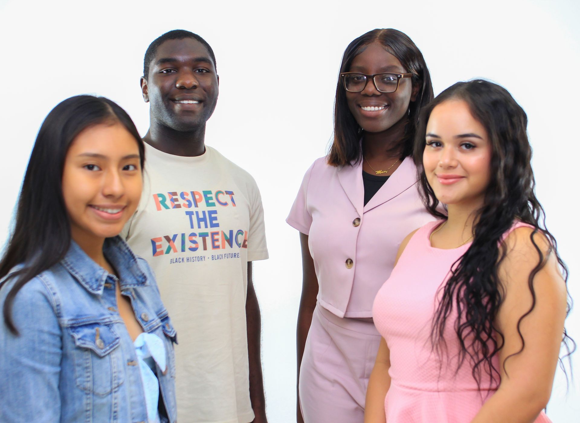 A group of young people are posing for a picture together.