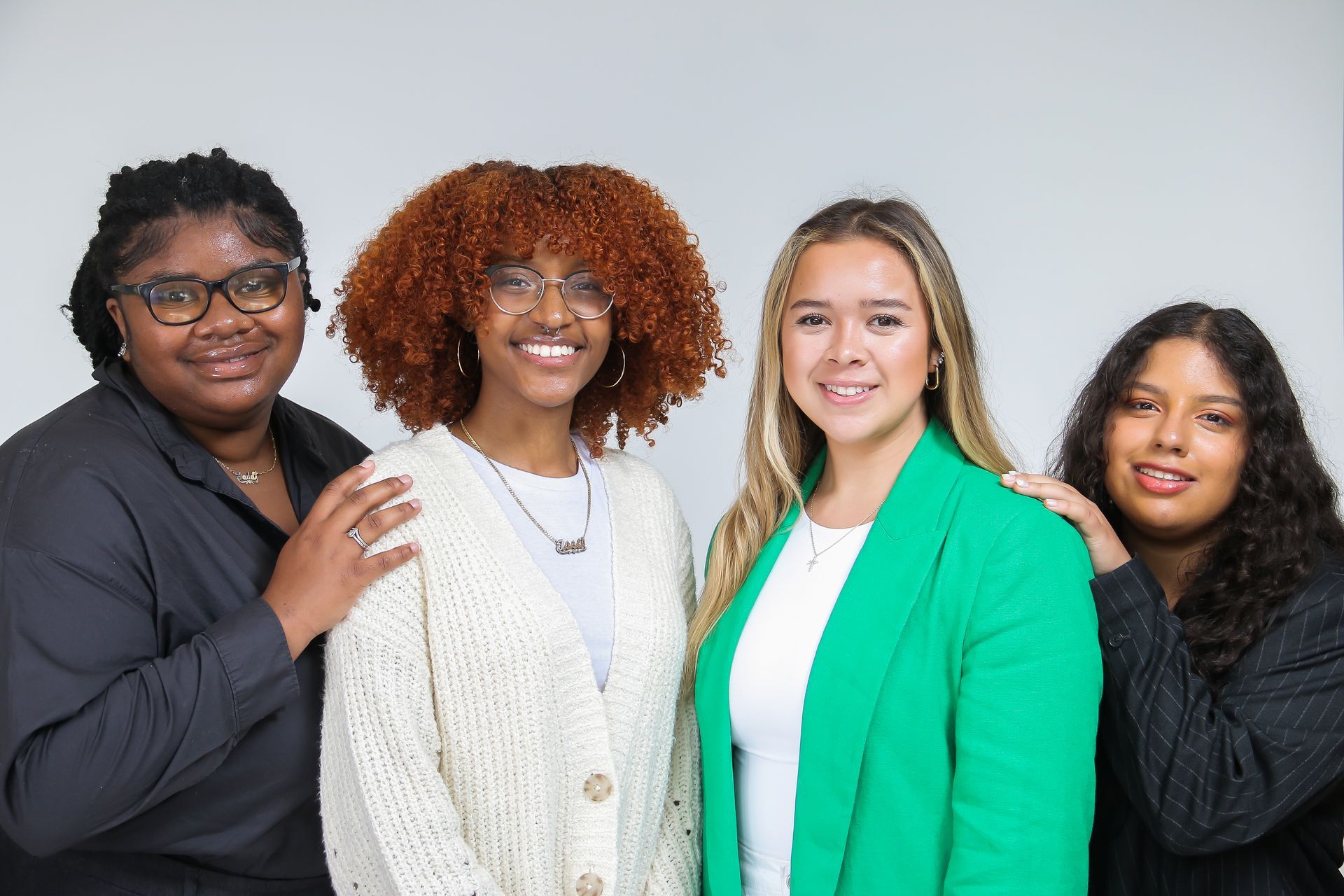 A group of young women are posing for a picture together.
