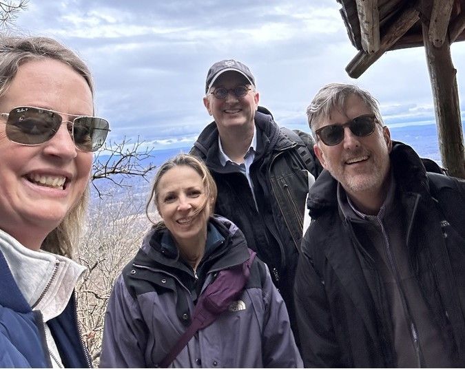 A group of people wearing sunglasses are posing for a picture