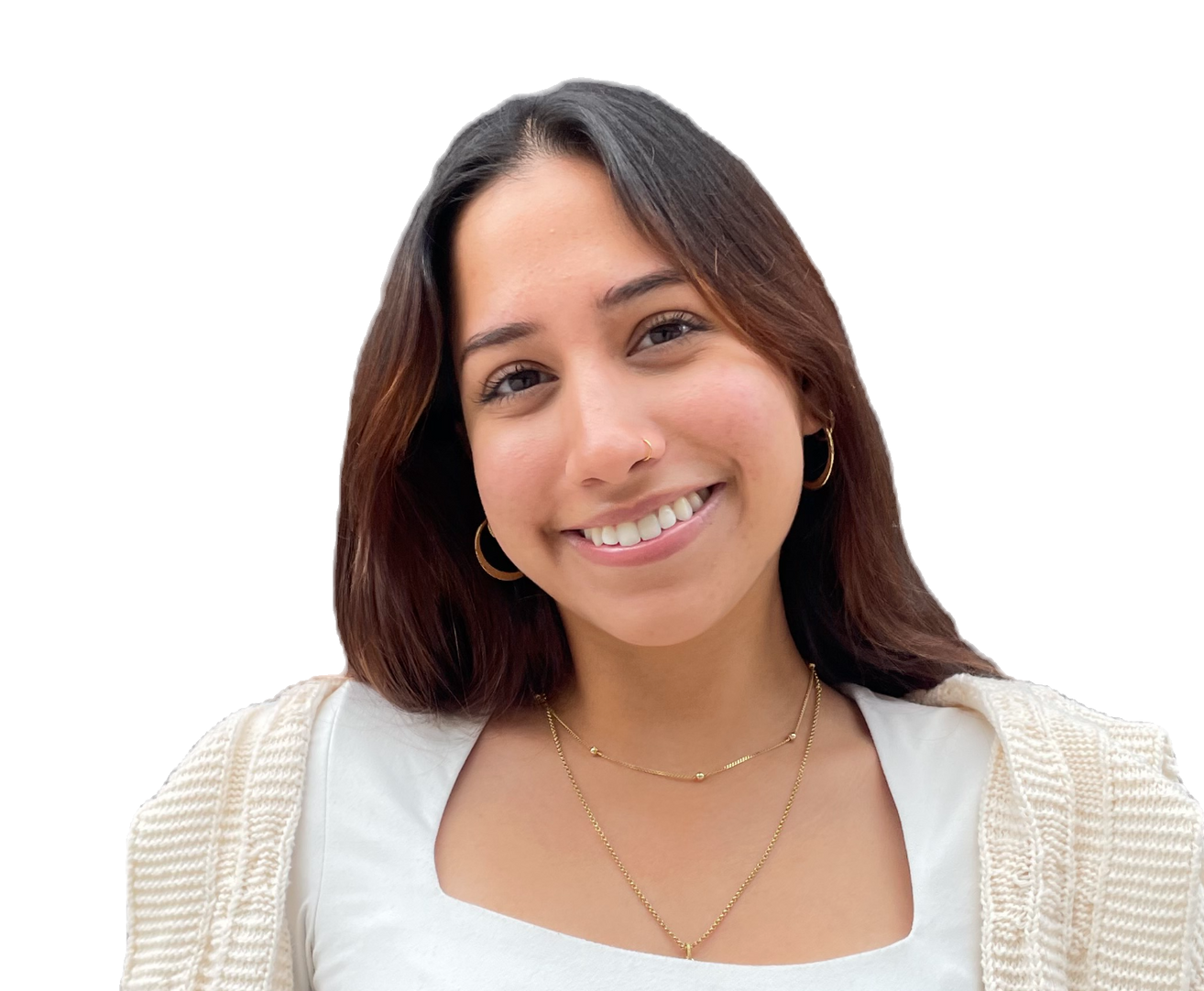 A woman wearing a white shirt and a tan sweater is smiling for the camera.