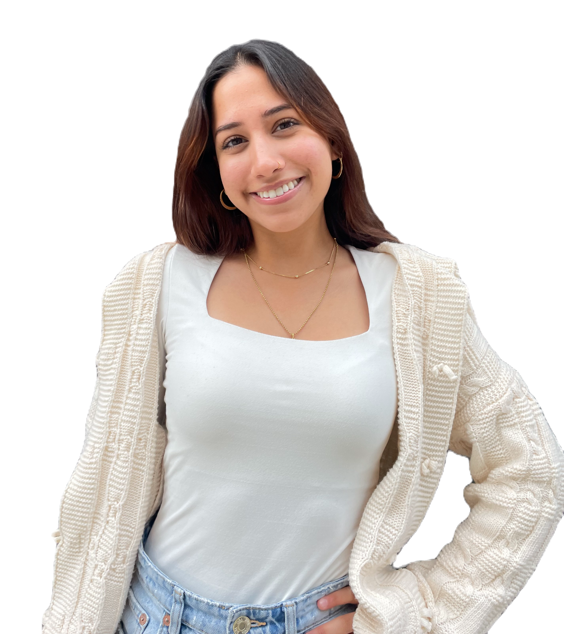 A woman wearing a white shirt and a white cardigan is smiling.