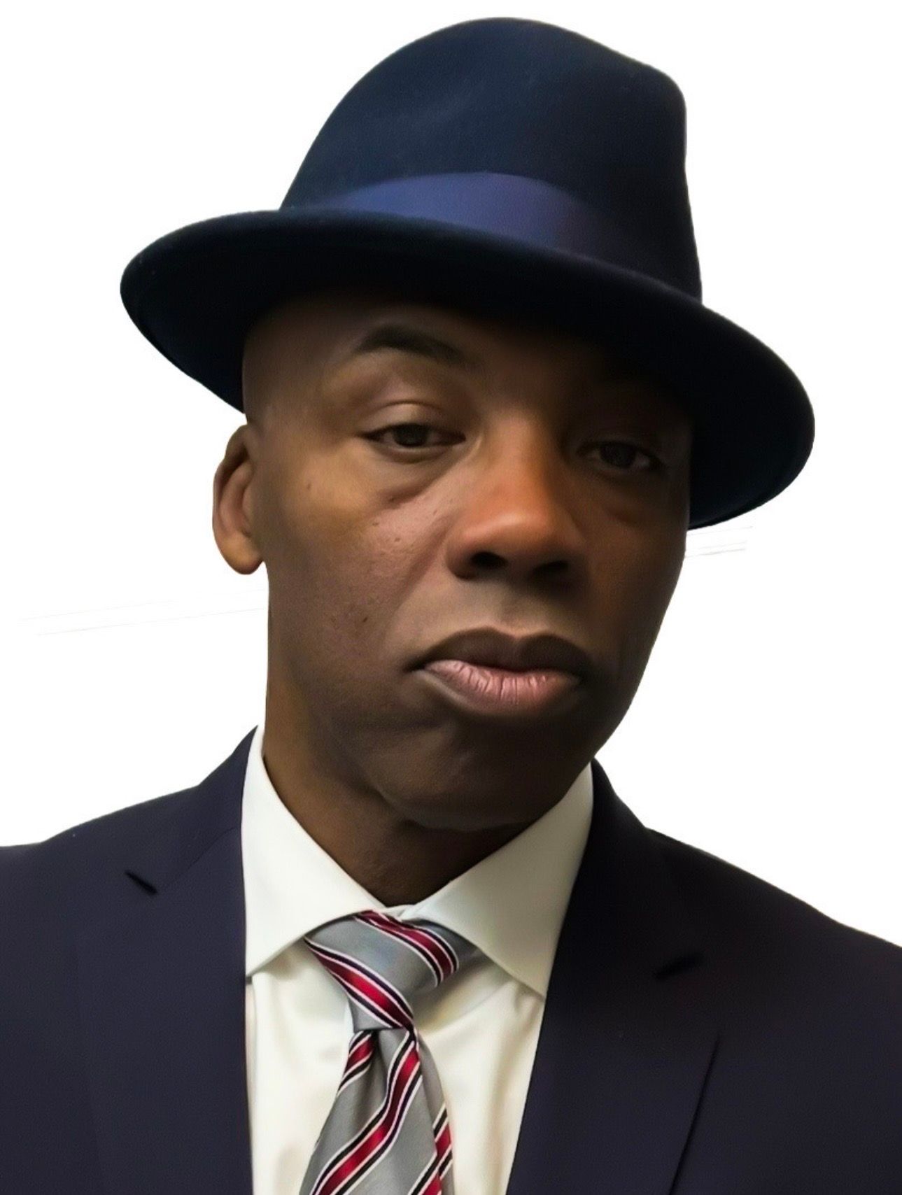 Man in a dark suit, striped tie, and navy fedora against a white background