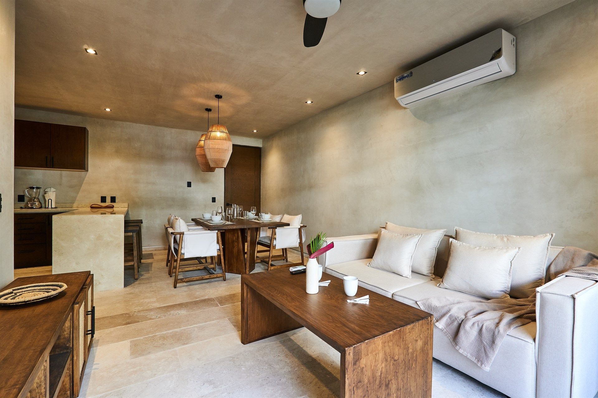 Una sala de estar con un sofá, una mesa, sillas y un ventilador de techo. Hotel Bakal Tulum