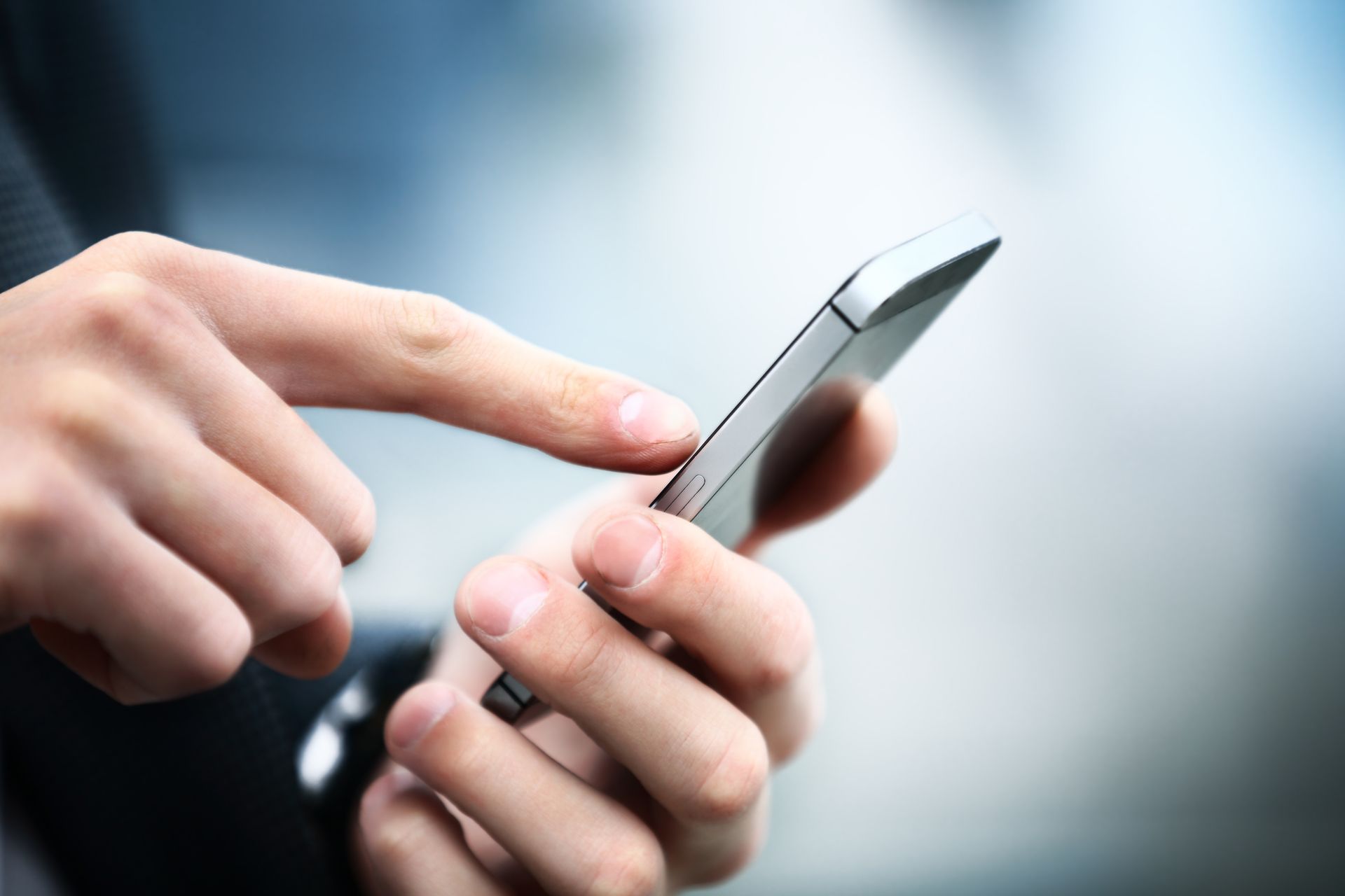 A person is using a cell phone with their finger on the screen.
