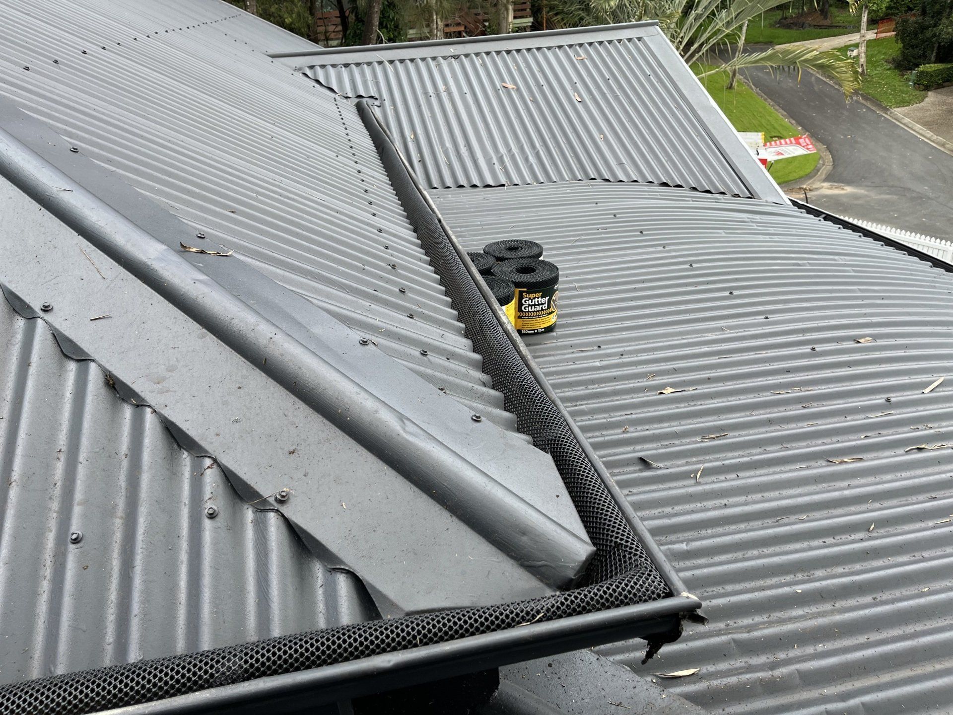Gray Metal Roof With a Black Edge and a Few Canisters on It — Jackson's Window Cleaning in Nerang, QLD
