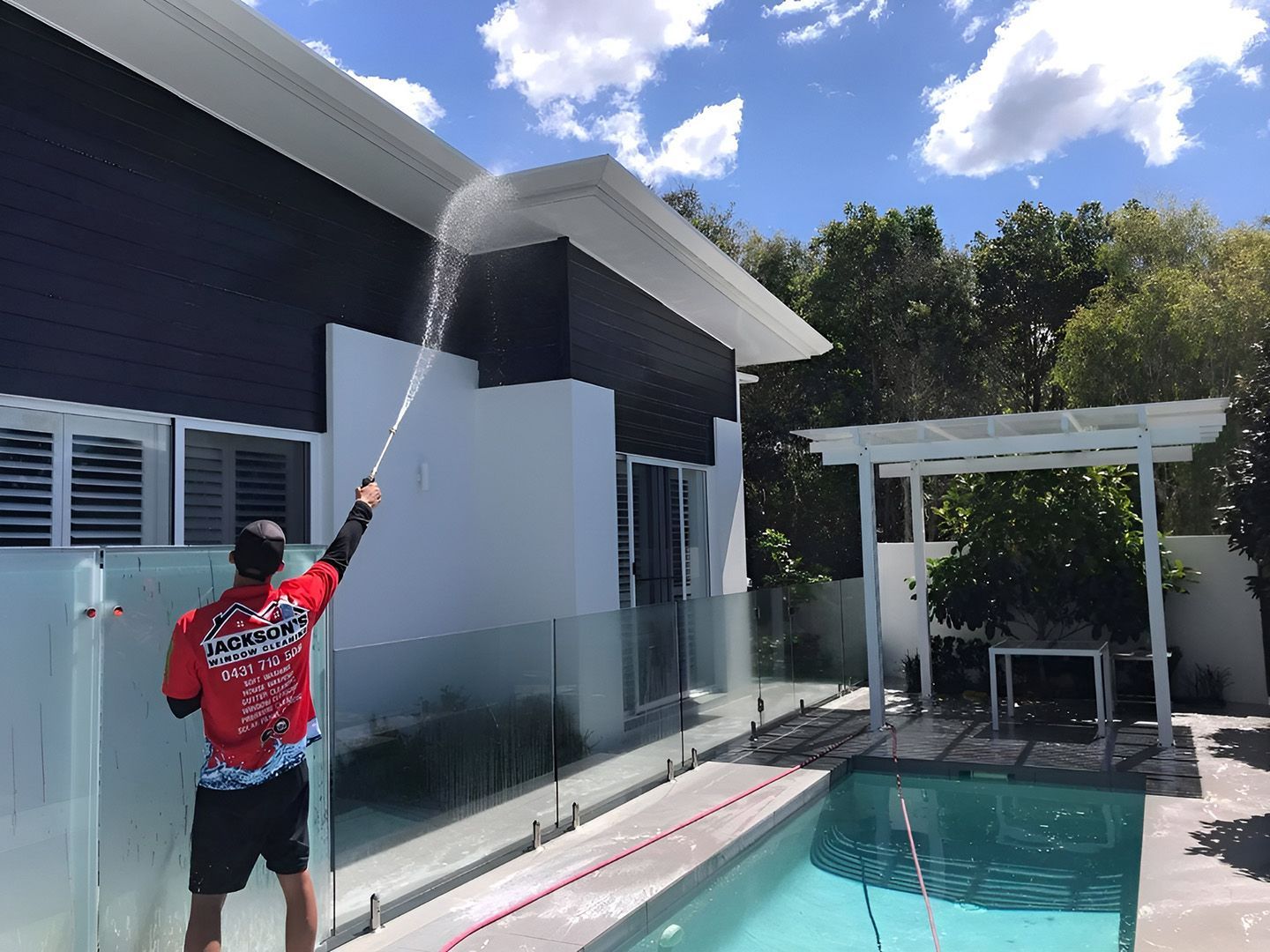 Exterior House Washing With Pressure Cleaner On Modern Home