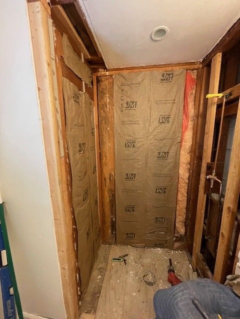 Bathroom remodel with exposed framing and insulation.