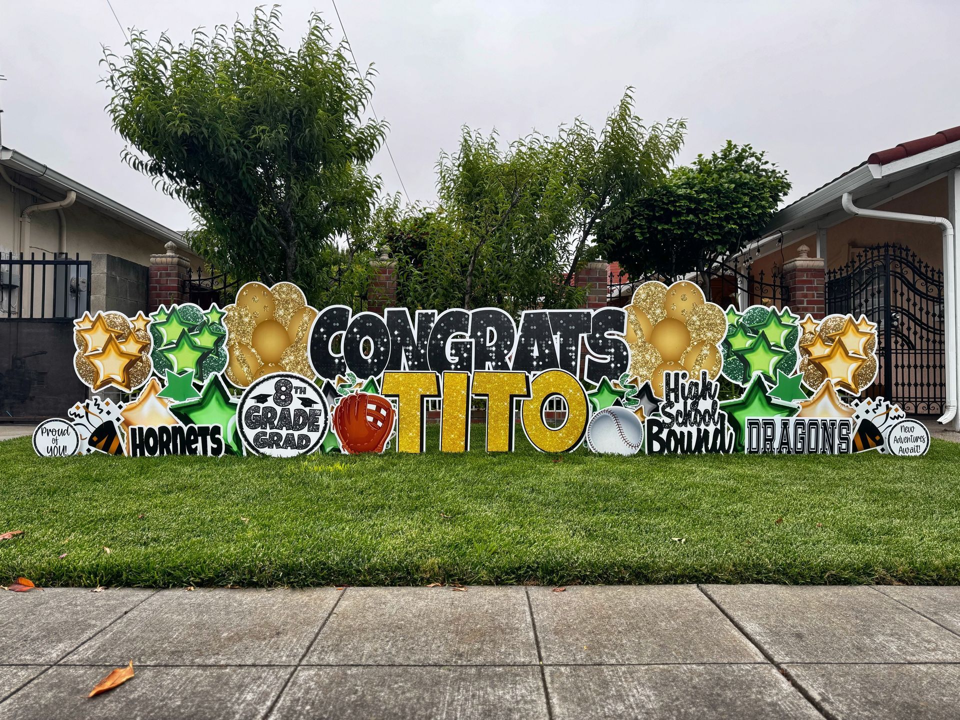 Deluxe graduation display in green, gold, and black. It states Congrats Tito. 