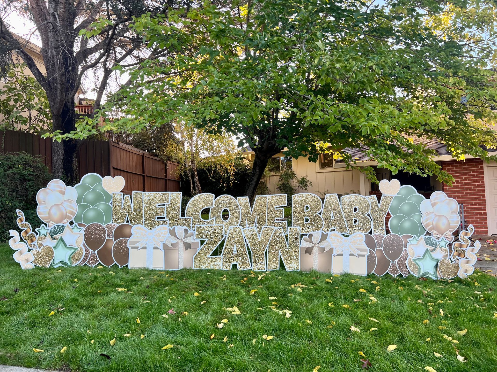 Welcome baby display in sage green and brown. 