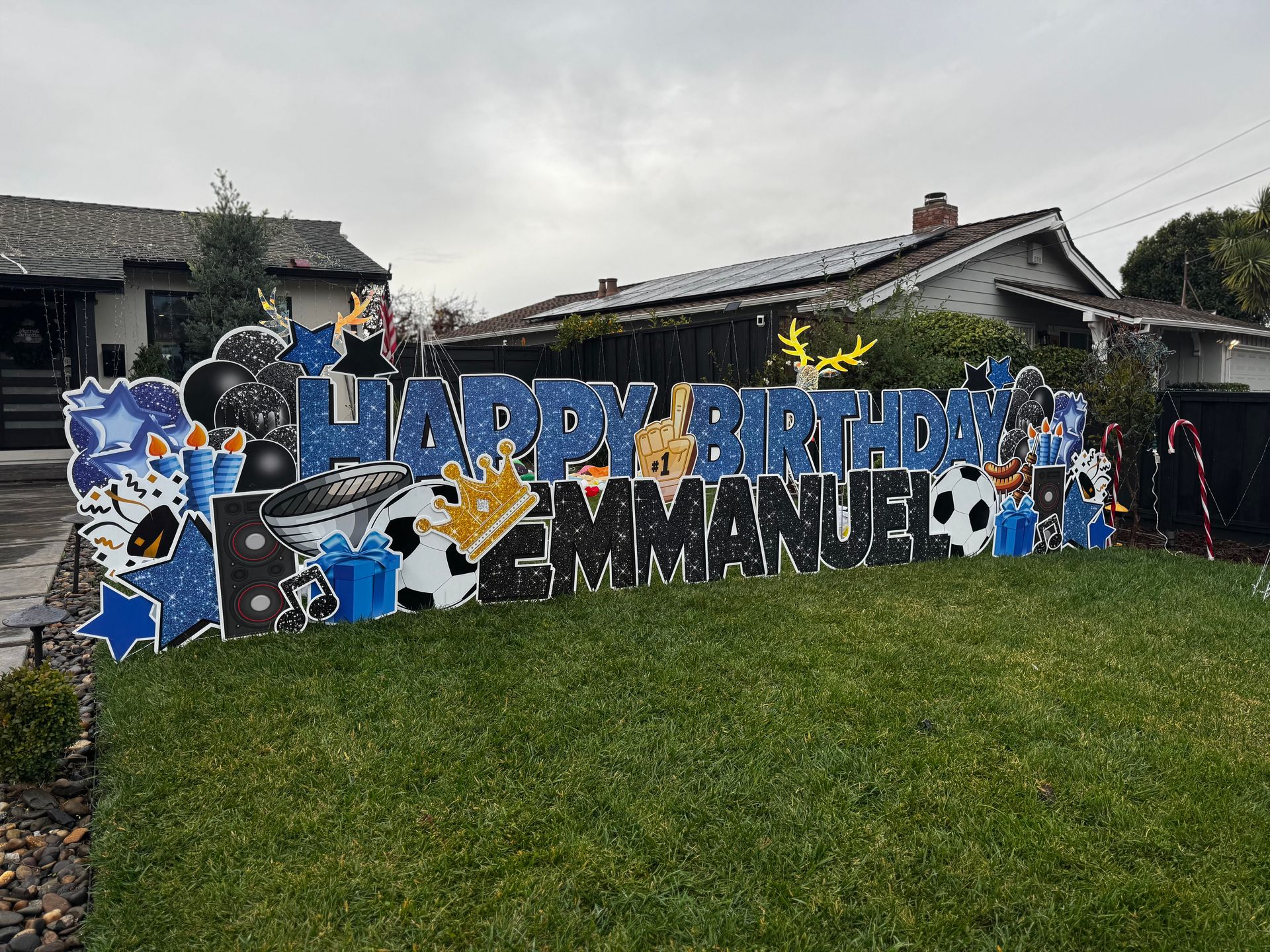 Themed display wishing happy birthday to Emmanuel in the colors blue and black. 