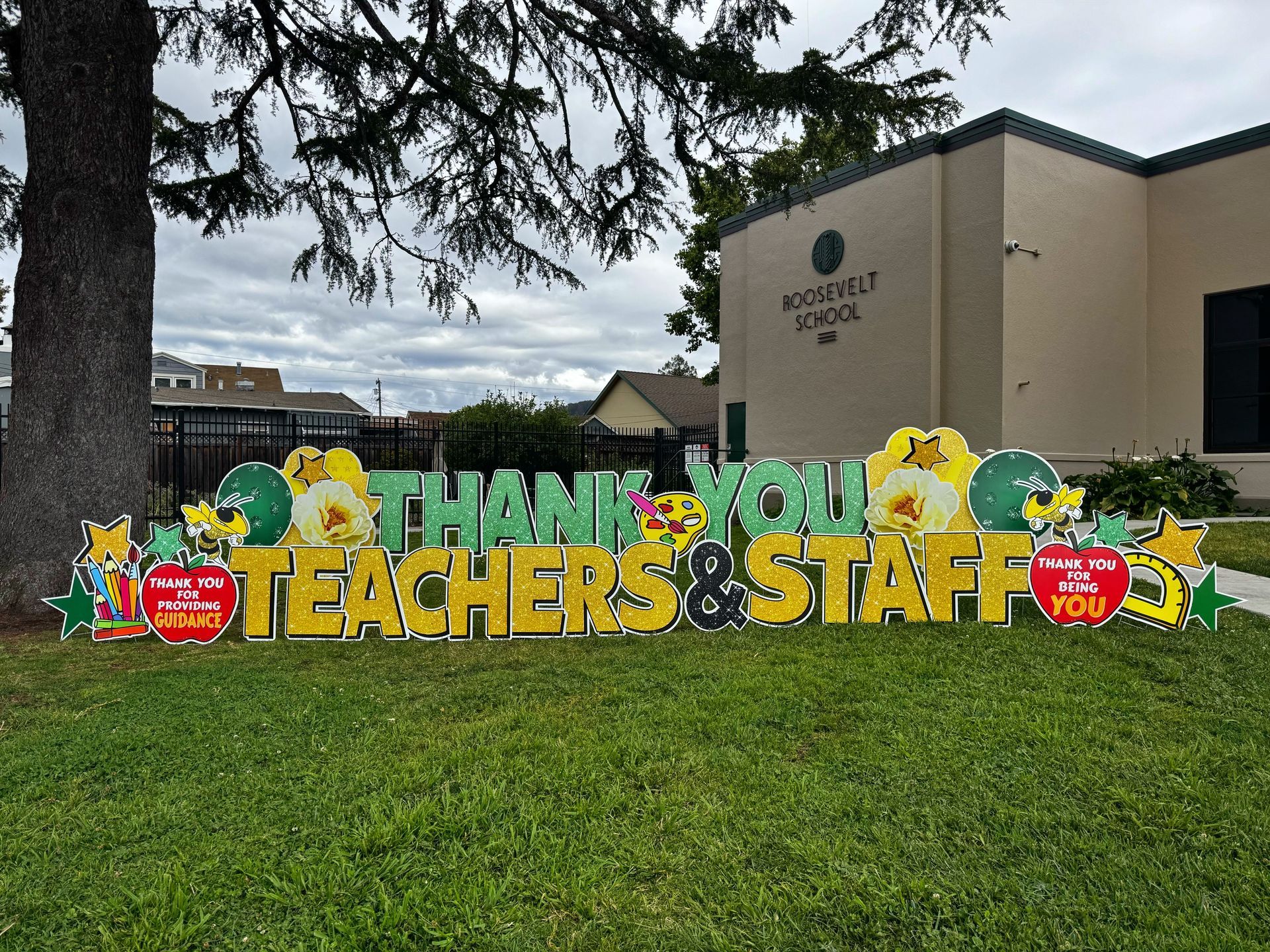 Teacher appreciation display in green and  yellow. It says thank you teachers and staff. 