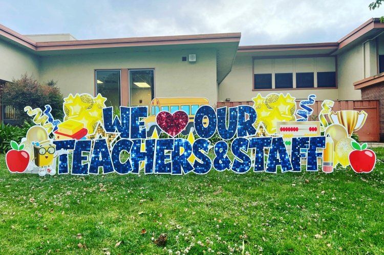 We love our teachers and staff school greeting. Yellow balloons and school related items. 