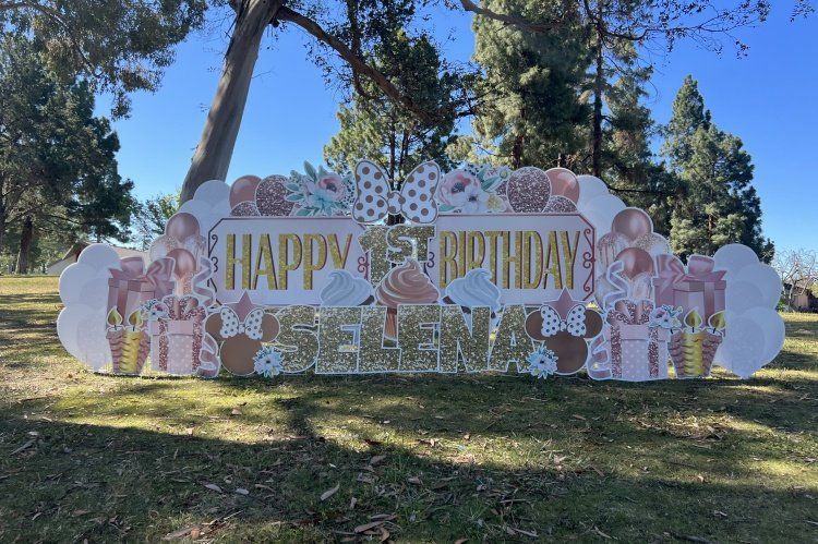 Rose gold, and light pink yard card birthday display. Happy birthday Selena with balloons, presents, flowers. 