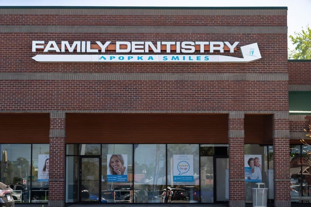 A brick building with a sign that says family dentistry
