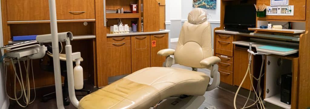 A dental office with a dental chair and dental equipment.