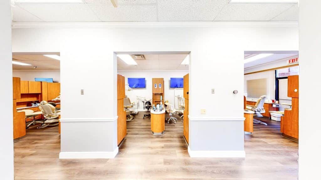 A dental office with a lot of cabinets and chairs.