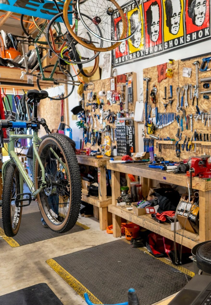 A bicycle is parked in a bicycle repair shop.