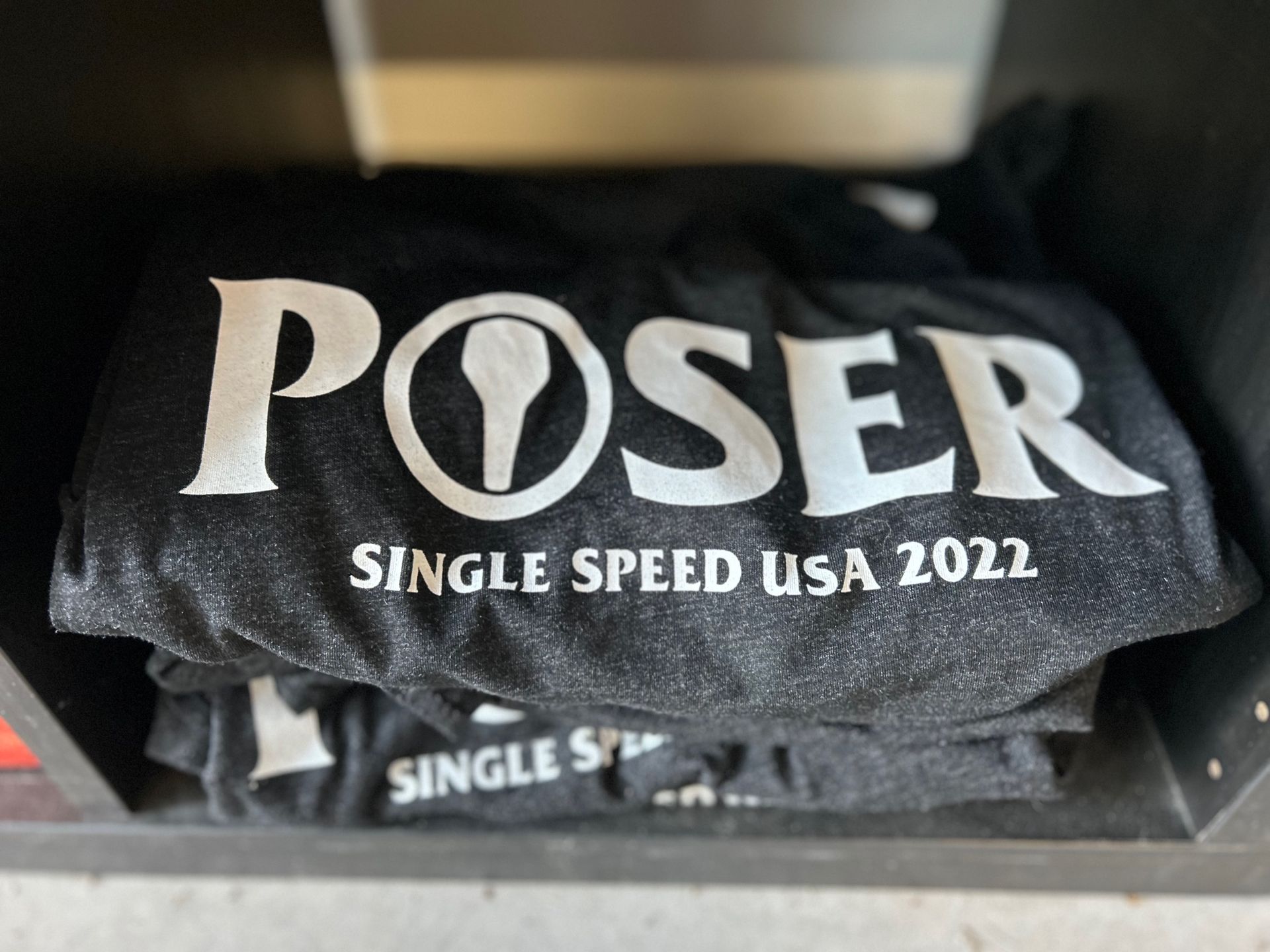 A black shirt with the word poser on it