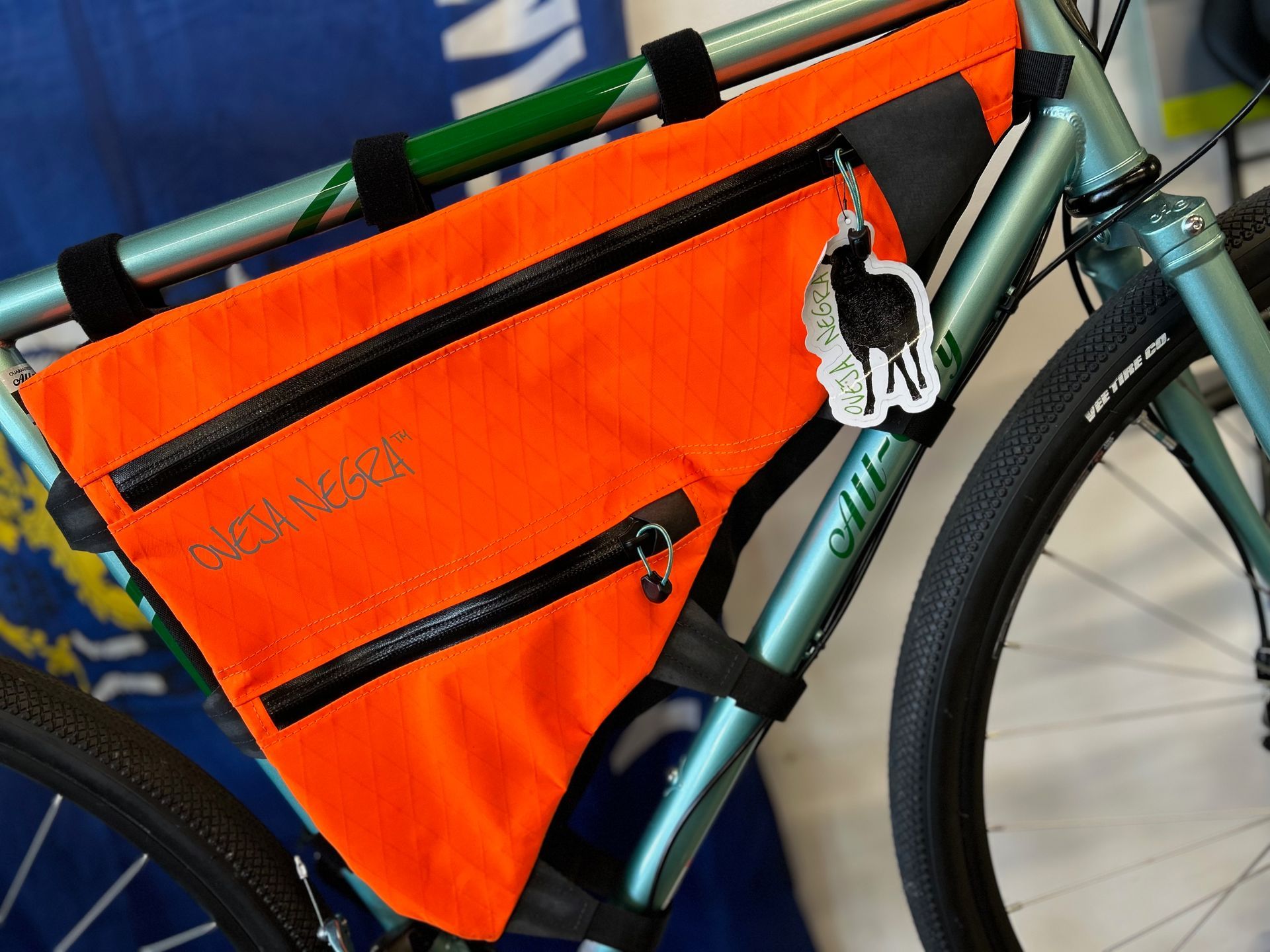A bicycle with an orange frame bag on it
