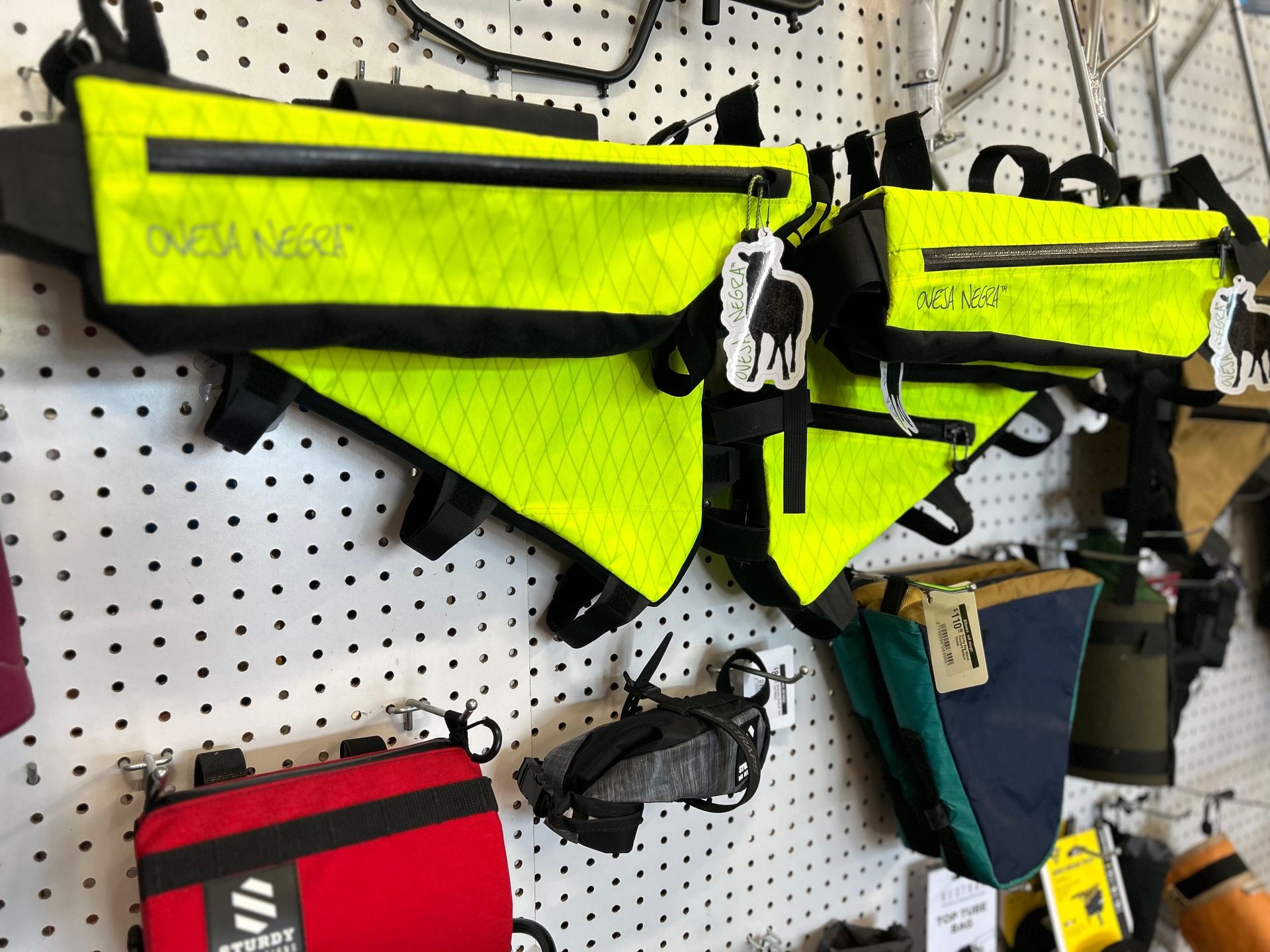A bunch of bags are hanging on a wall in a store