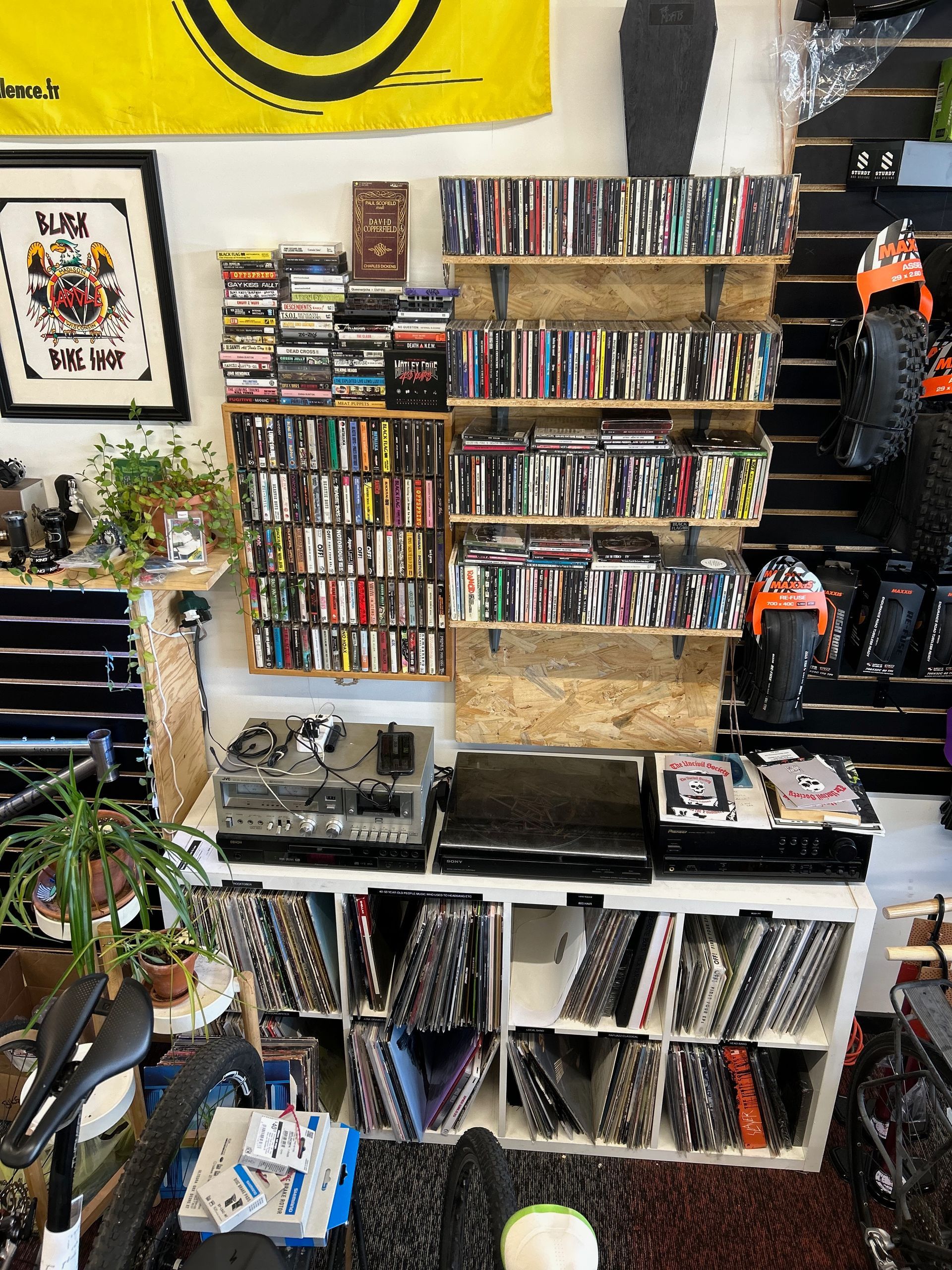 A room with a lot of books on shelves and a yellow flag on the wall.