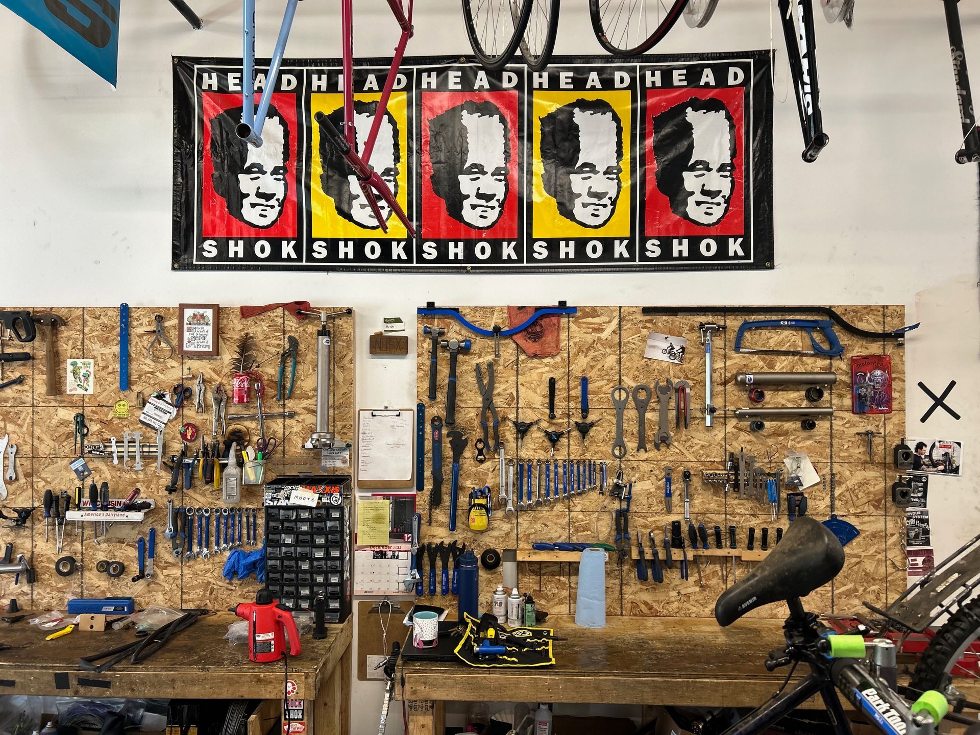 A bicycle shop with a sign on the wall that says ' head head head head '