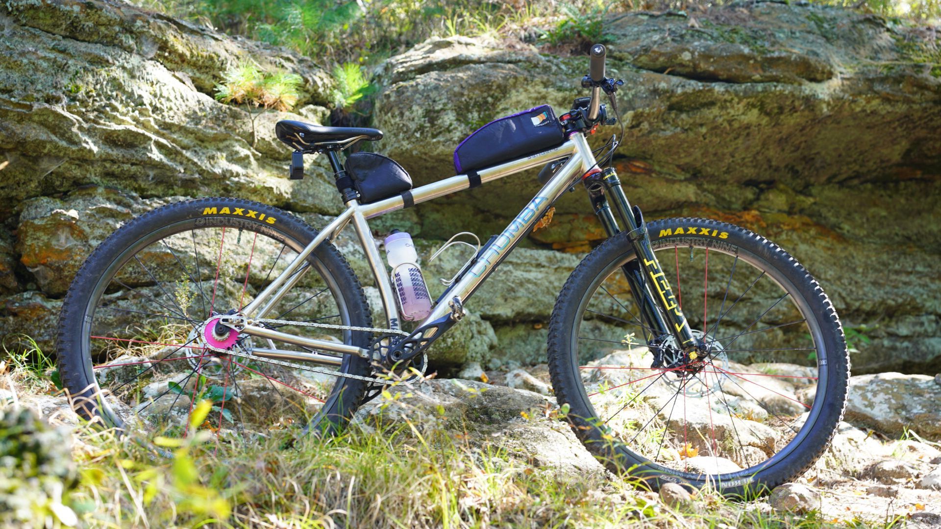 A bicycle is parked on a rocky hillside.