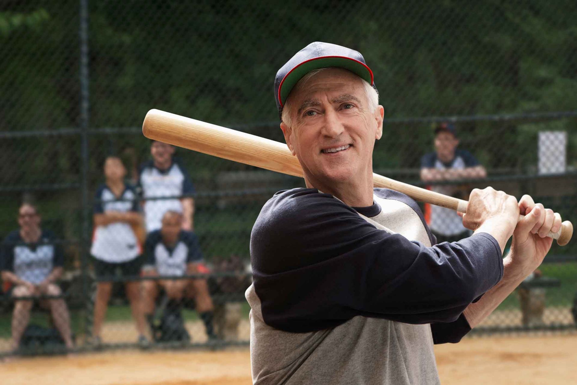 A man is swinging a baseball bat on a baseball field.