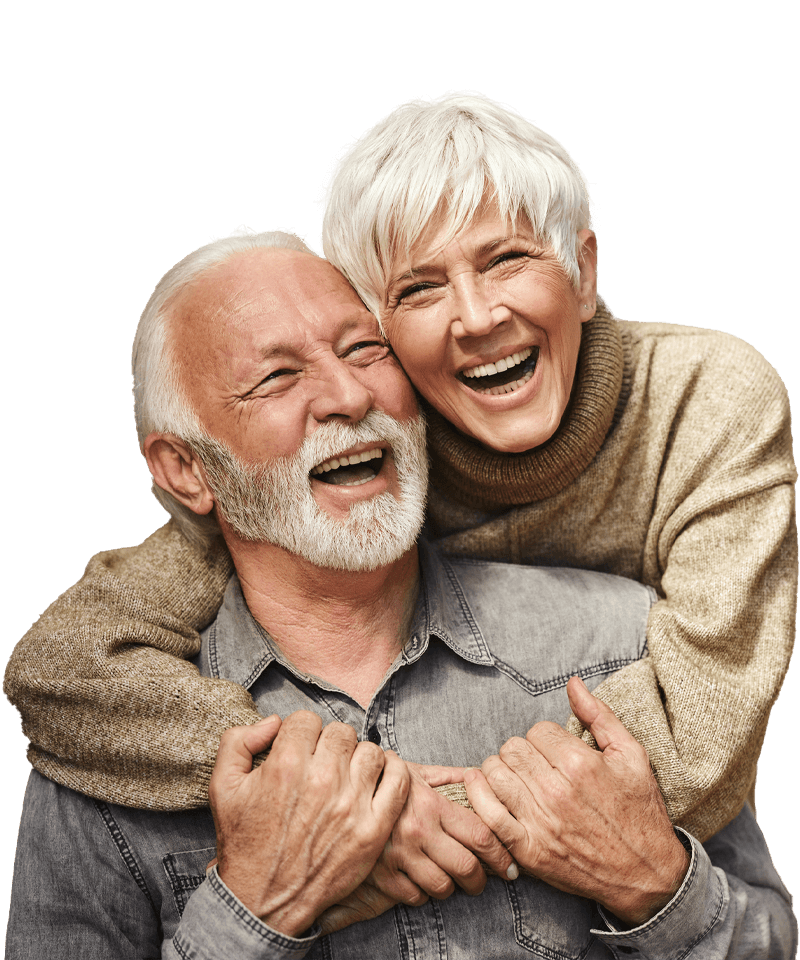 A man and a woman are hugging each other and smiling.