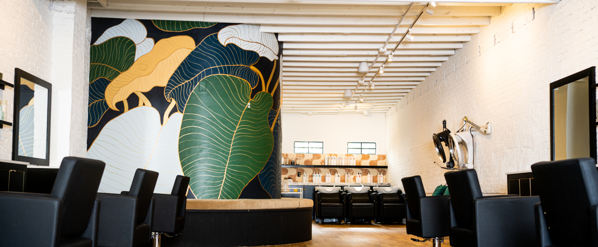 A large room with lots of chairs and a painting on the wall