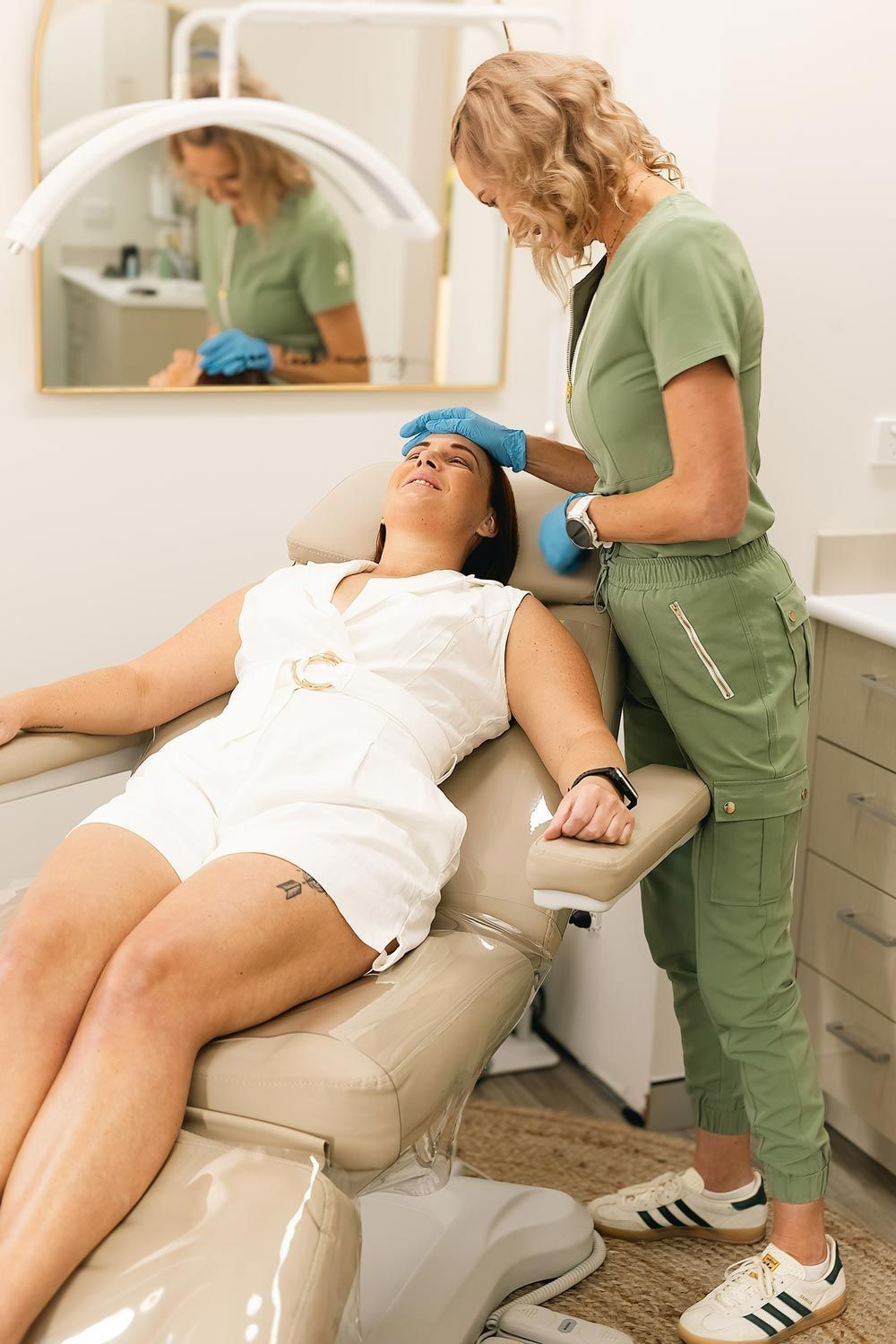 Woman in dental chair being examined by a healthcare professional.