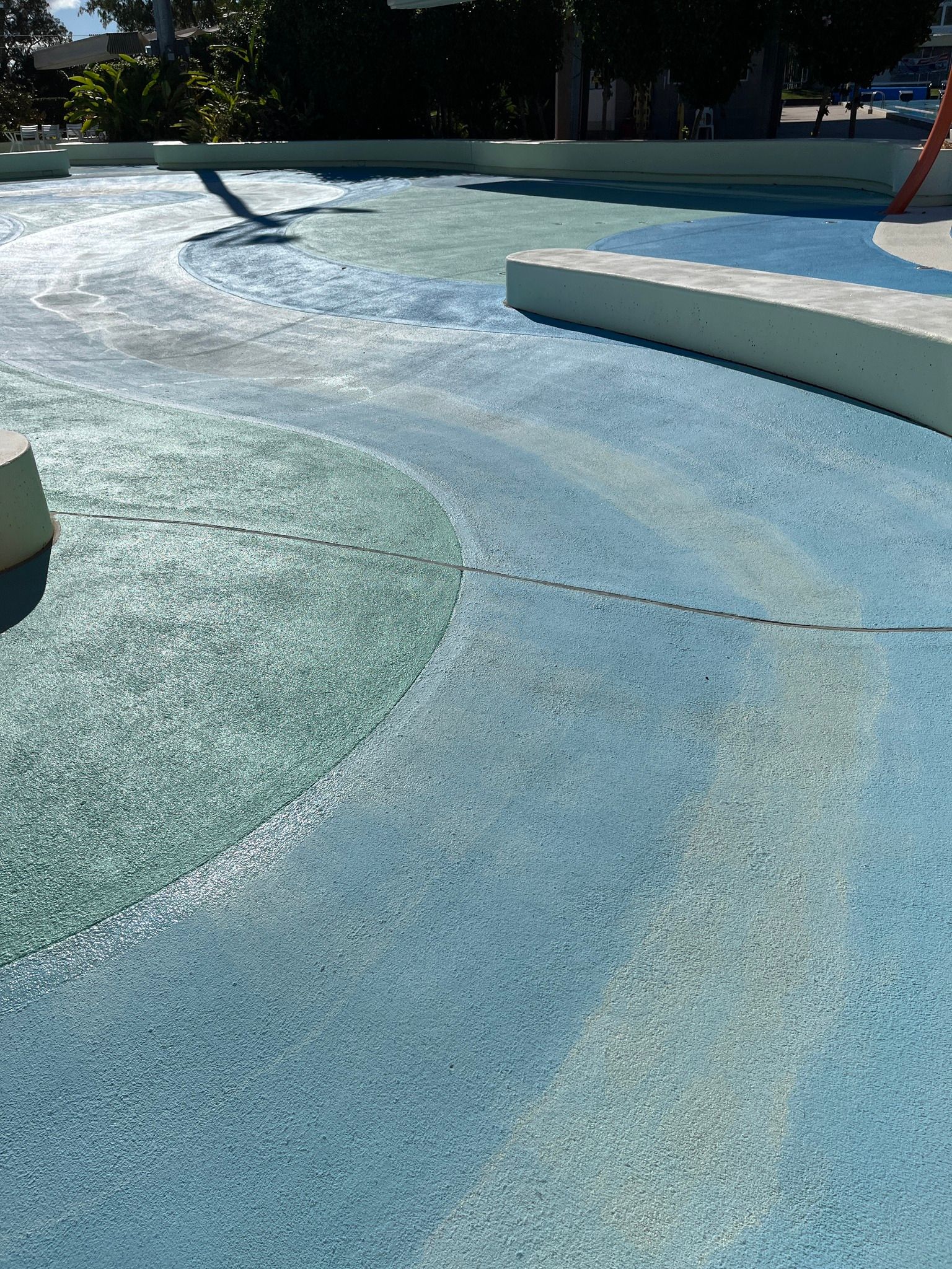 A Splash Pad Play Area With Light Green and Blue Rubber Flooring — Priority Painters in Gladstone Central, QLD