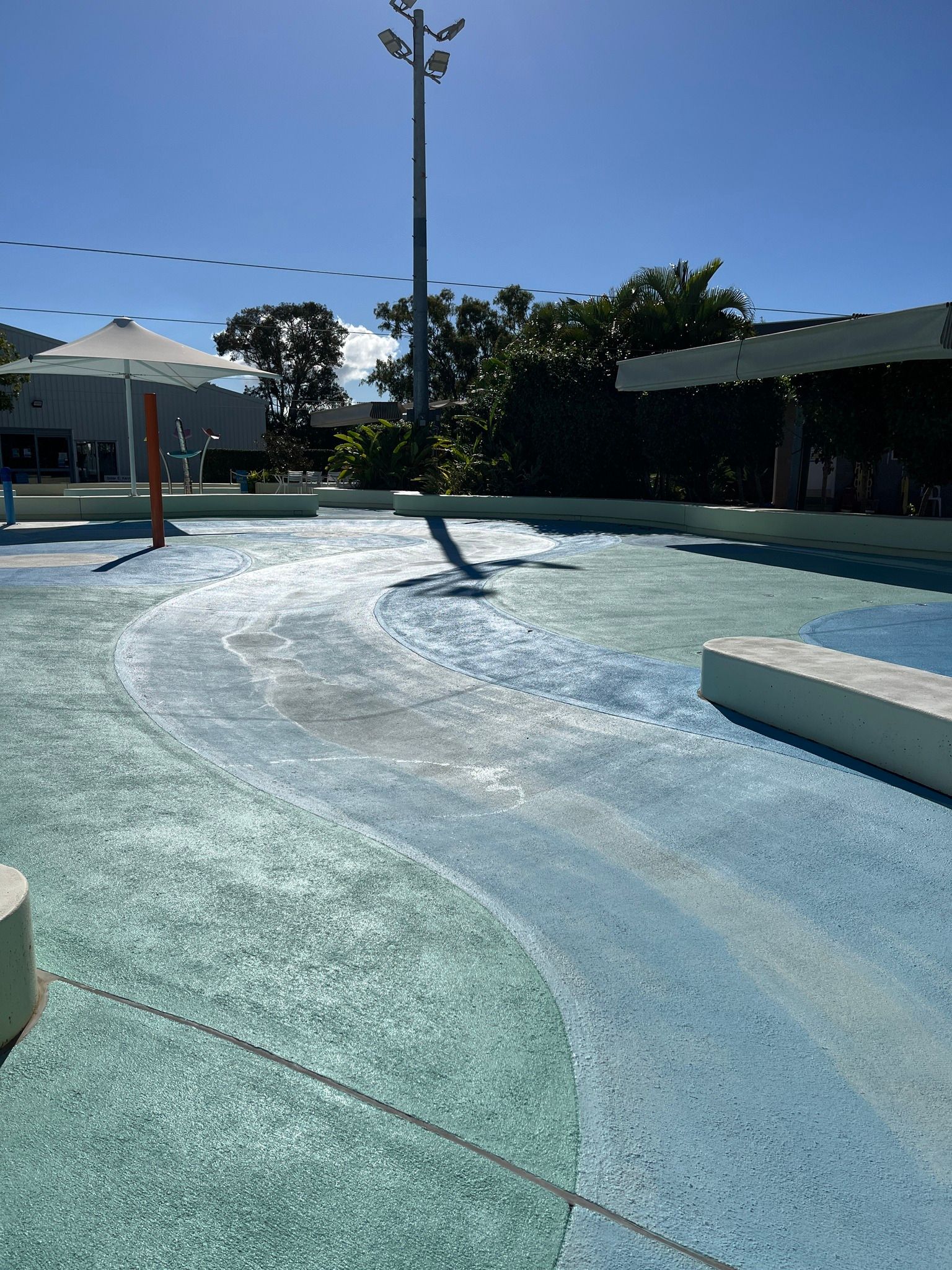 An Outdoor Splash Pad With a Curving Water Channel — Priority Painters in Gladstone Central, QLD