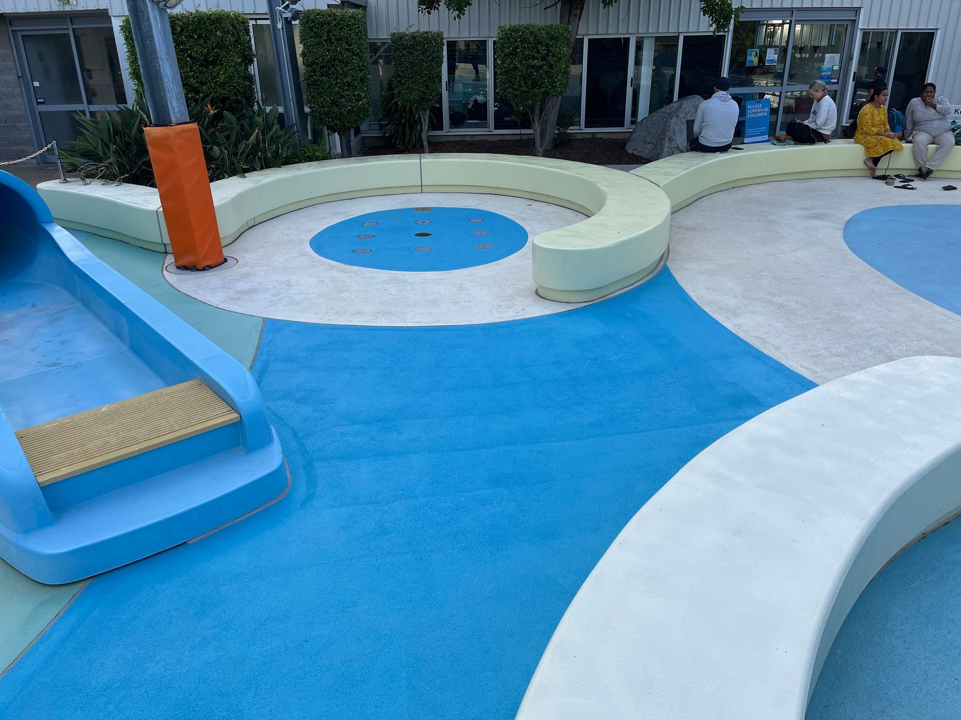 A Colorful, Outdoor Splash Pad Featuring Blue Ground Surfacing — Priority Painters in Gladstone Central, QLD