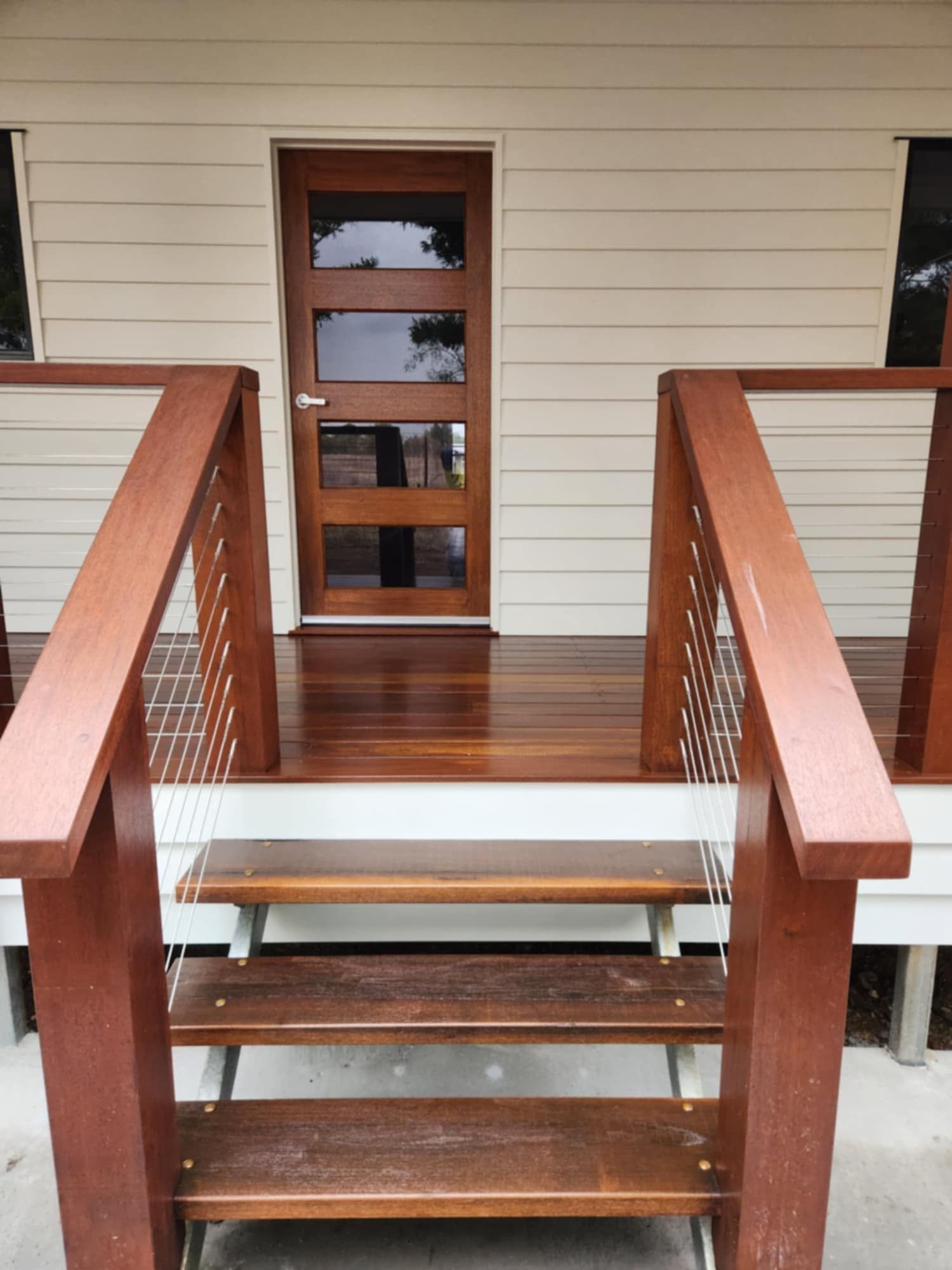 Three Wooden Steps With Metal Cable Railings — Priority Painters in Gladstone Central, QLD