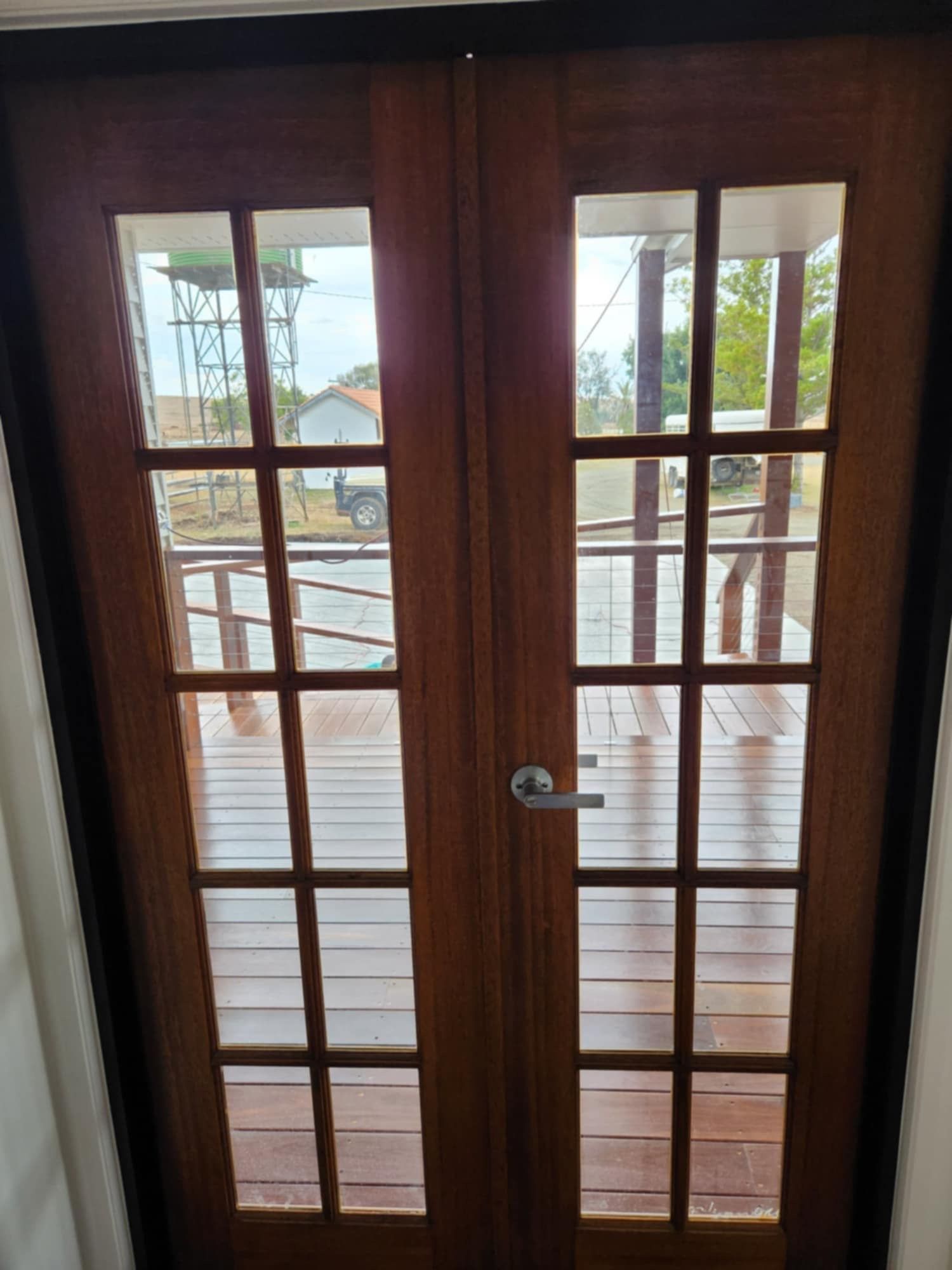 A Set of Brown Wooden French Doors With Glass Panes — Priority Painters in Gladstone Central, QLD