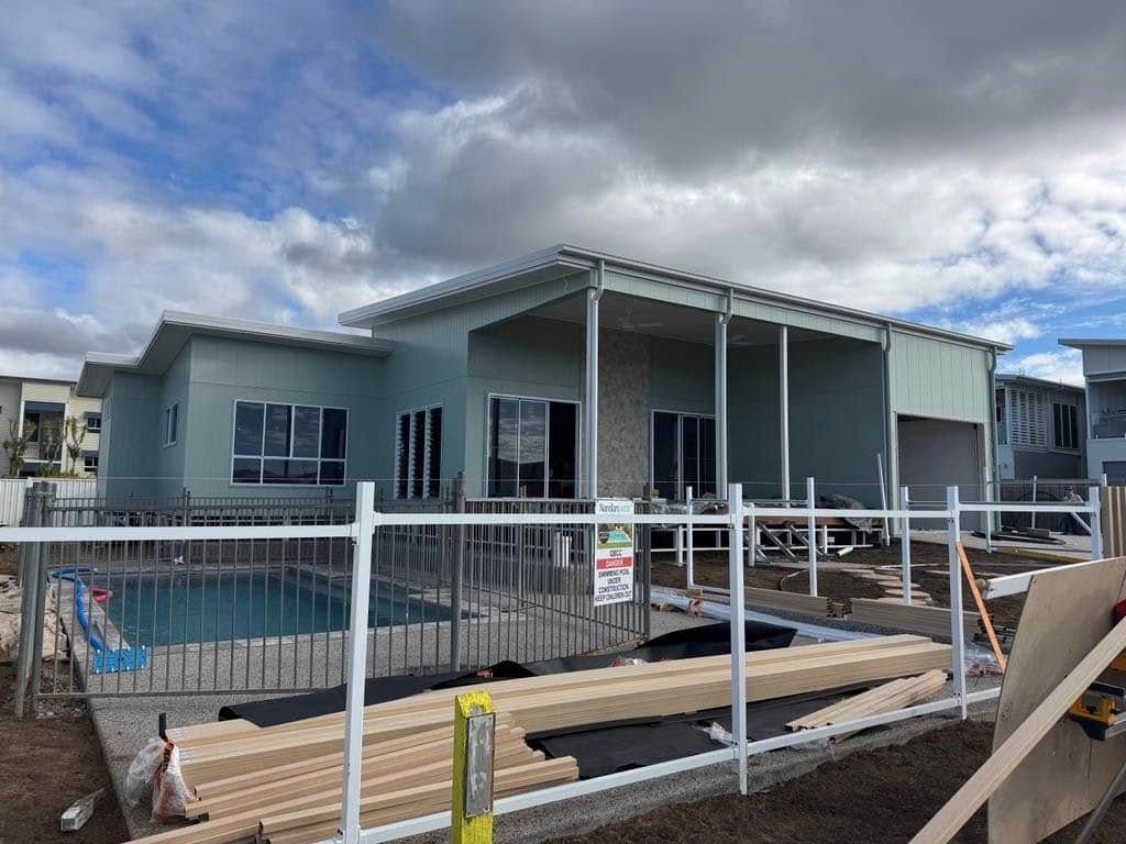 A Light Blue Modern House With a Covered Patio and Pool Under Construction — Priority Painters in Gladstone Central, QLD