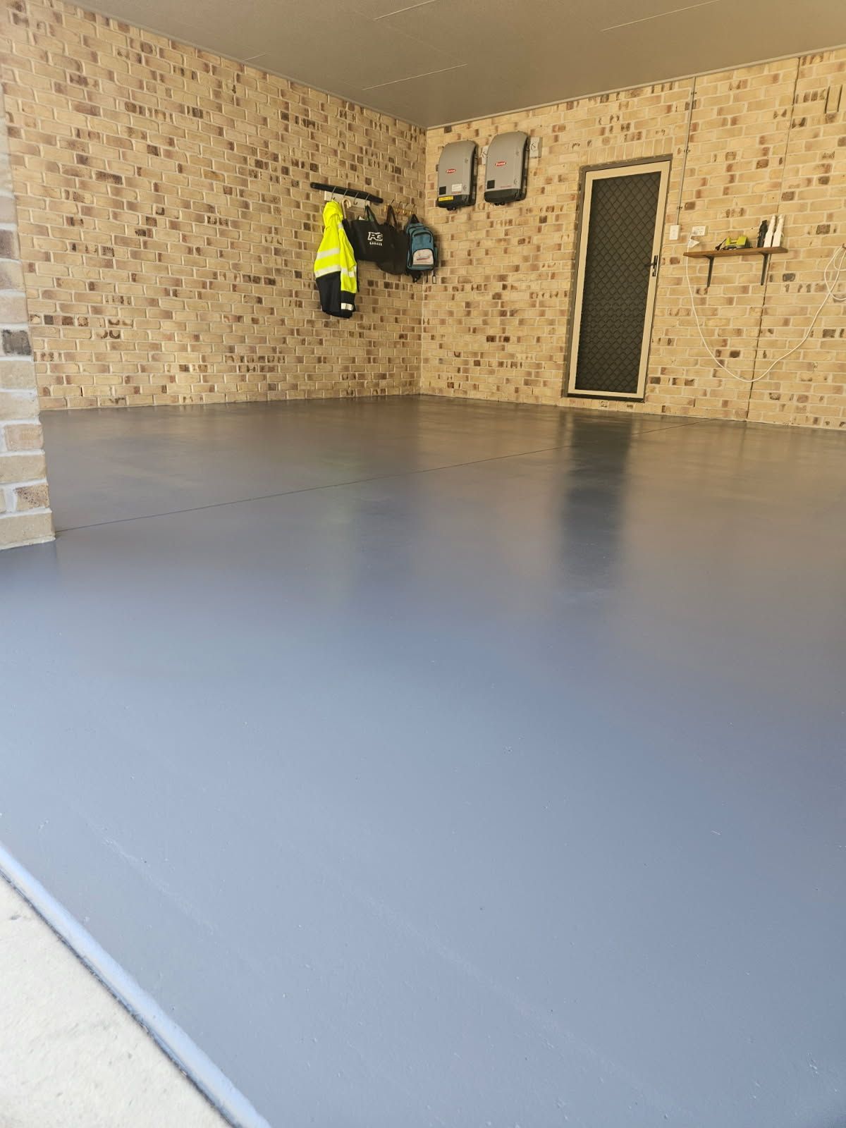 An Empty Garage with Epoxy Flooring — Priority Painters in Tannum Sands, QLD