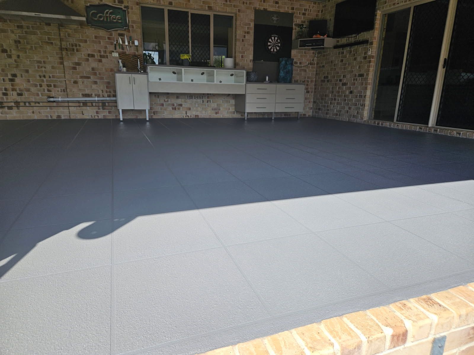 A Clean, Gray Patio Floor With a Speckled Finish — Priority Painters in Gladstone Central, QLD