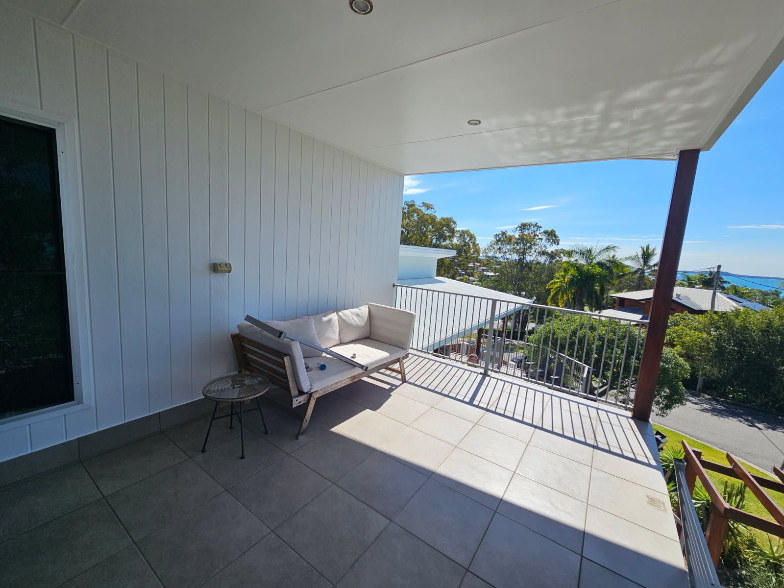 A Light-colored Outdoor Sofa and Small Side Table — Priority Painters in Gladstone Central, QLD