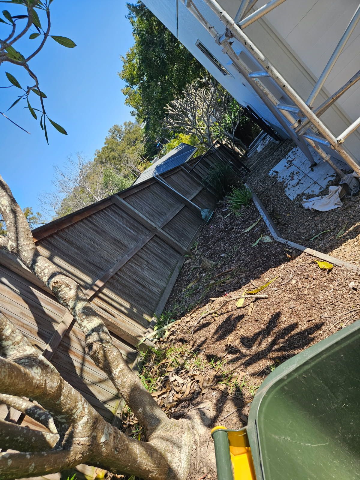 A Wooden Fence Runs Along a Narrow, Bark-covered Side Yard — Priority Painters in Gladstone Central, QLD