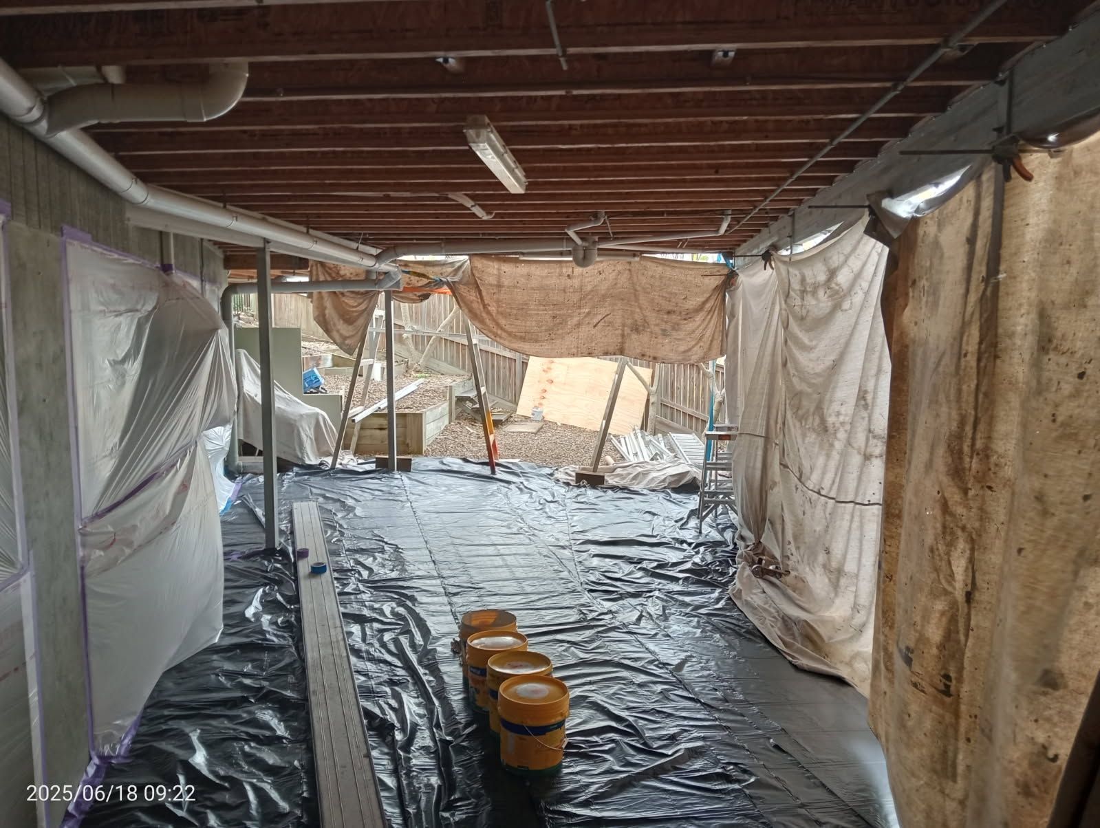 An Indoor Crawl Space Under Renovation, With Plastic Sheeting on Walls — Priority Painters in Gladstone Central, QLD
