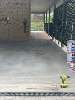 A Garage Floor Mixing Attachment Sitting Near a Row of Paint Buckets — Priority Painters in Gladstone Central, QLD