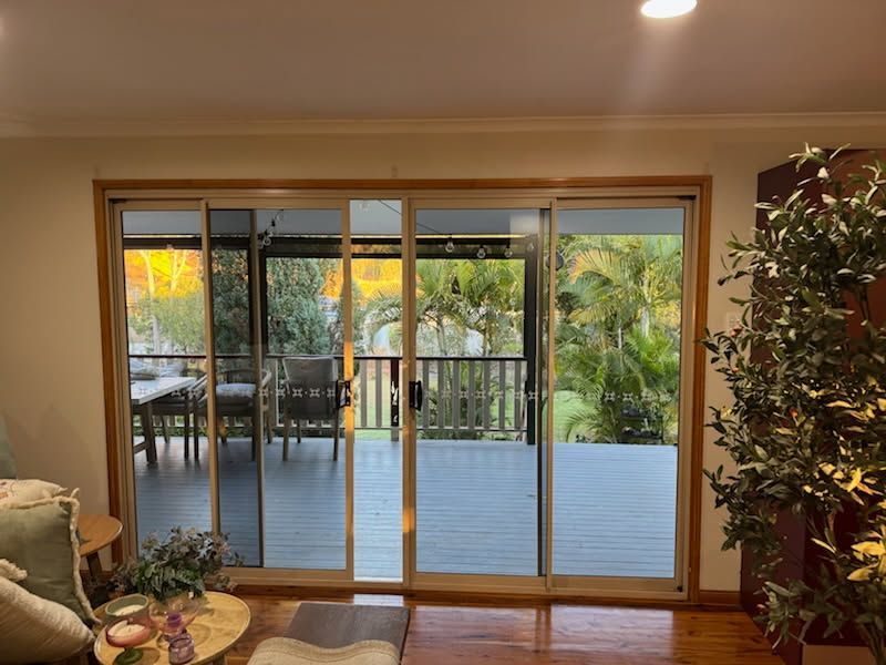 A View From Inside a Room Through Large Sliding Glass Doors — Priority Painters in Gladstone Central, QLD