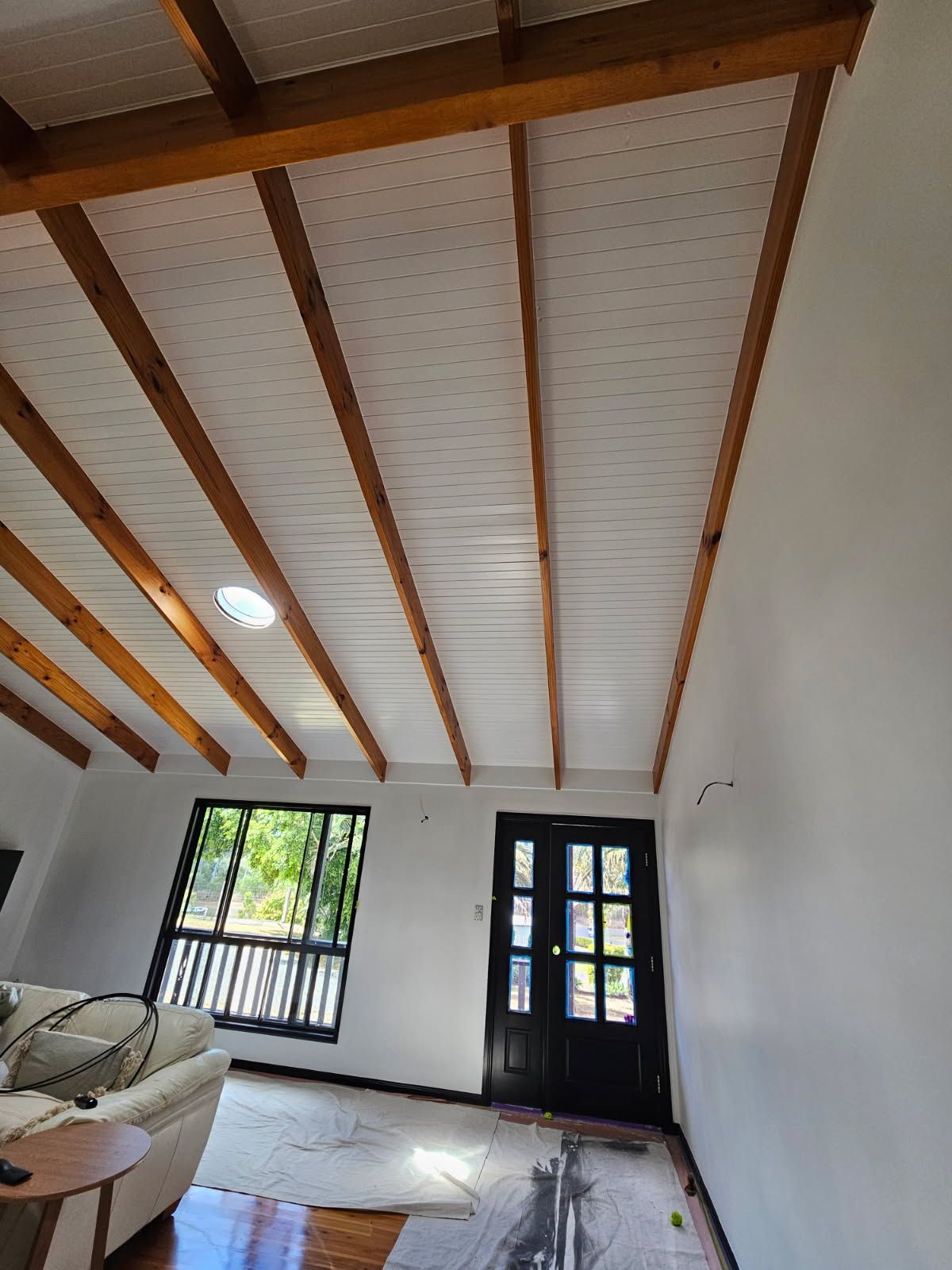 An Interior Room With Exposed Wooden Ceiling Beams — Priority Painters in Gladstone Central, QLD