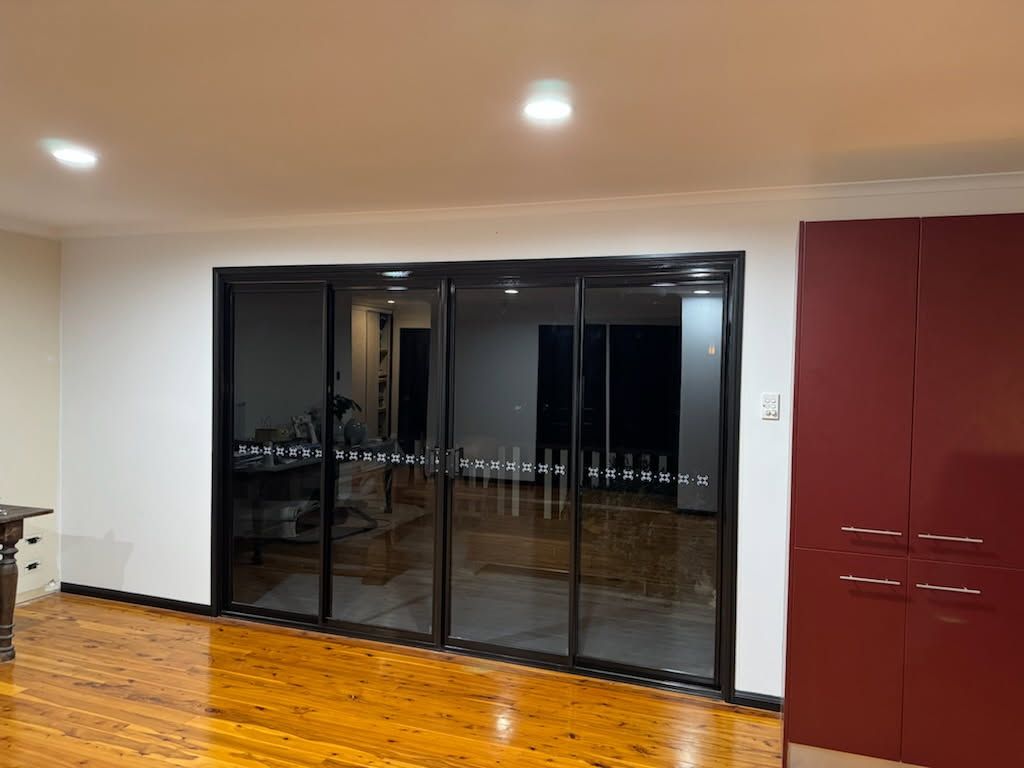 A Room With Polished Wooden Floors, White Walls — Priority Painters in Gladstone Central, QLD