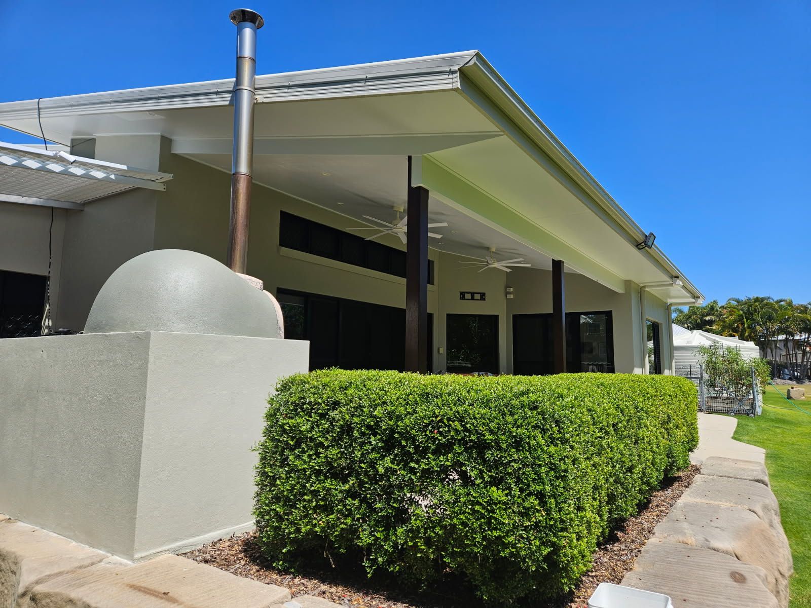 A Green Hedge in Front of a Modern House — Priority Painters in Gladstone Central, QLD