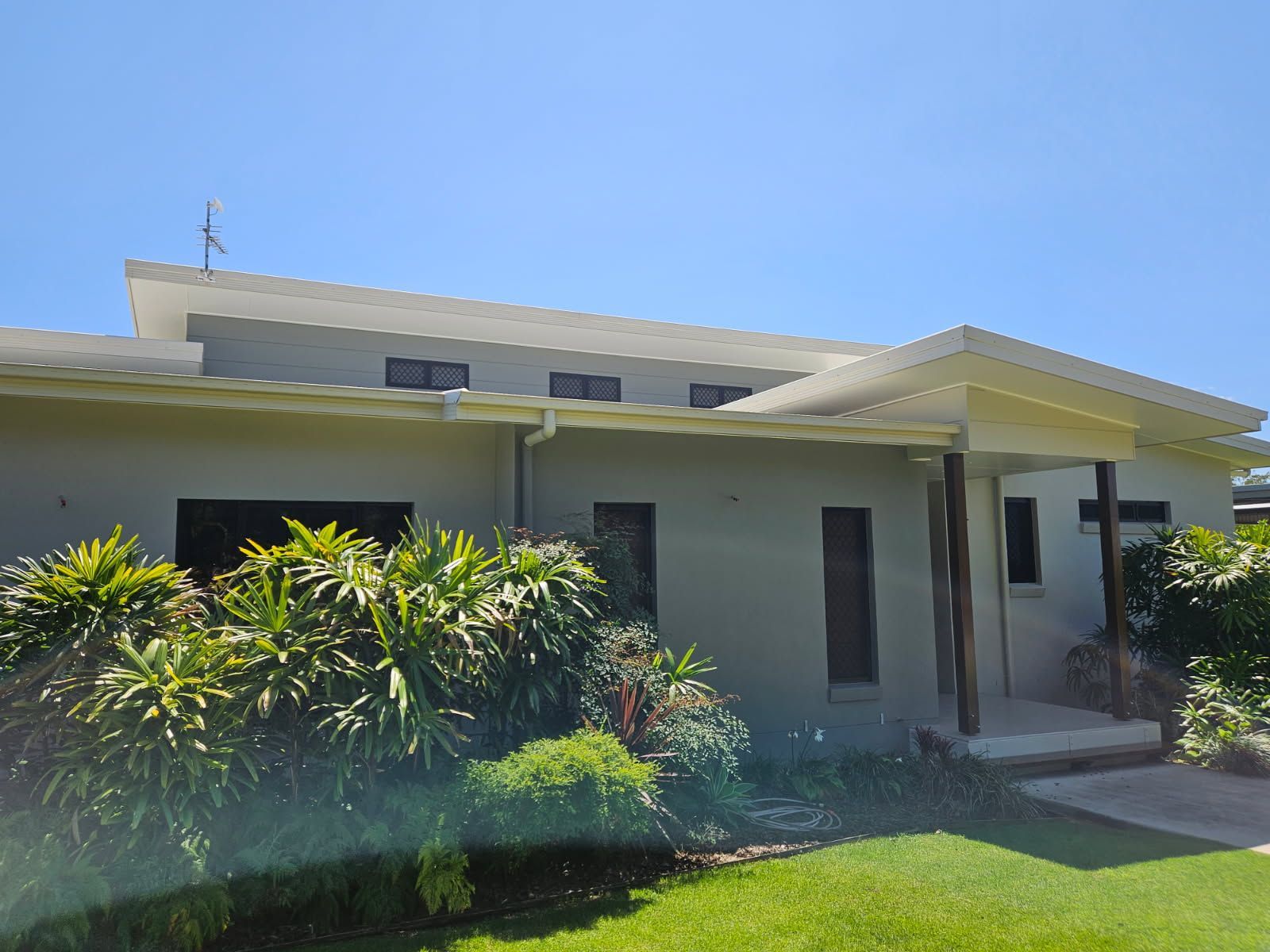 A Grey Single-story House With a White Roof and Covered Entrance — Priority Painters in Gladstone Central, QLD