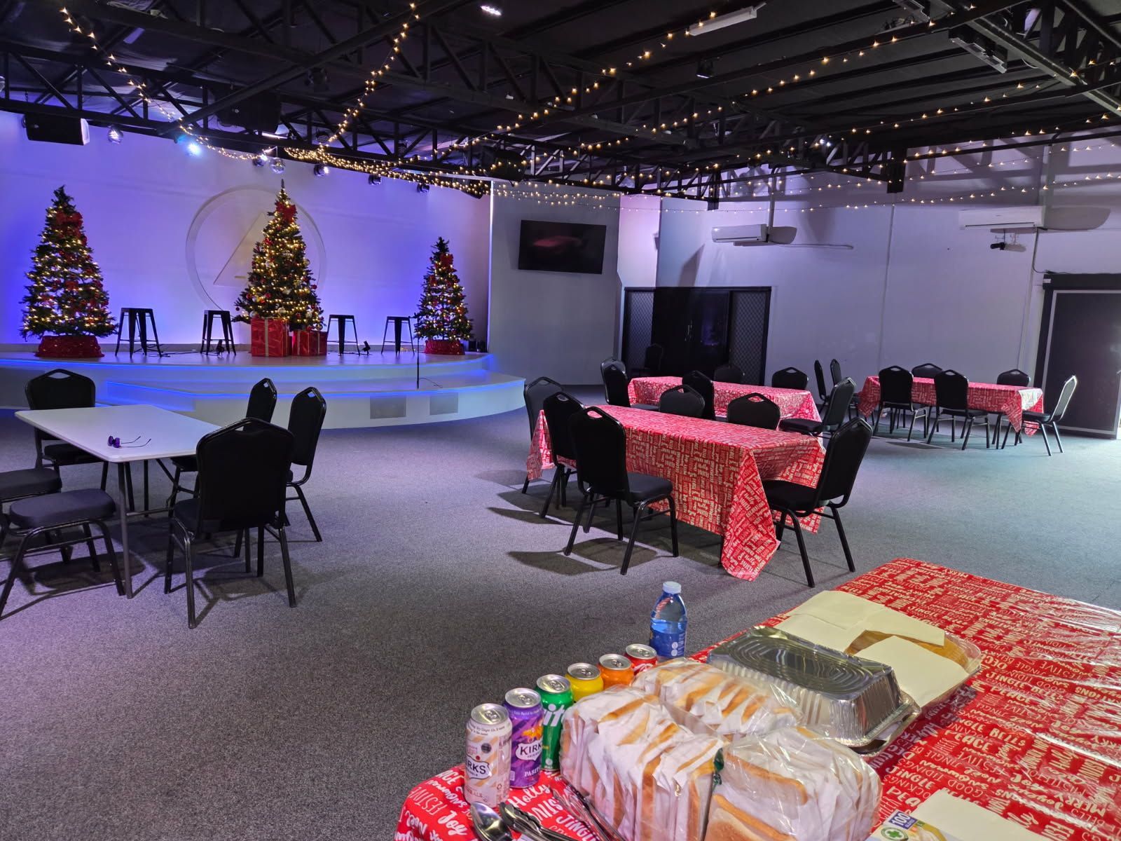 A Banquet Hall Decorated for Christmas, Featuring Three Lit Trees — Priority Painters in Gladstone Central, QLD