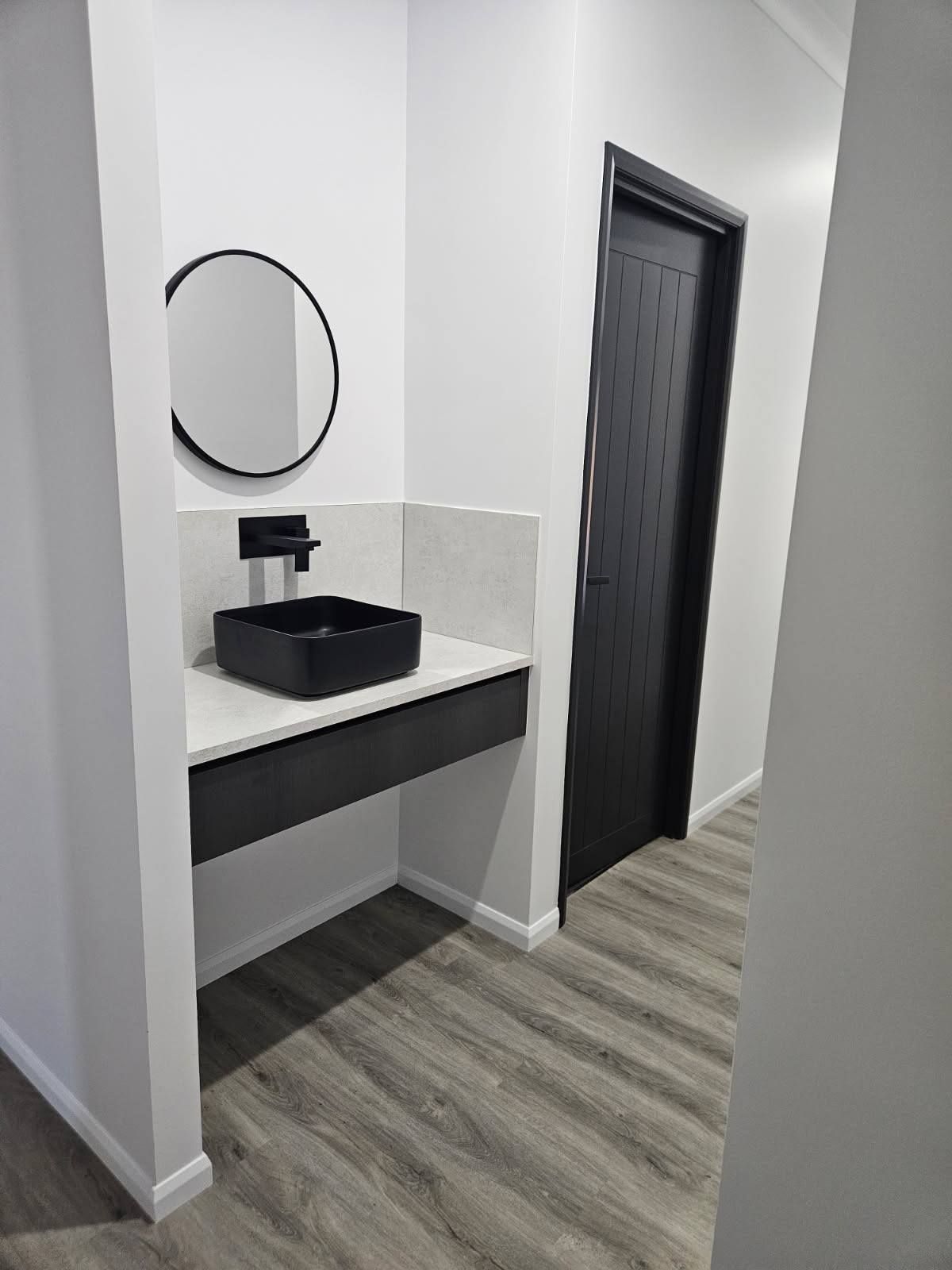 A Modern Bathroom Vanity With a Square Black Sink, and Black Faucet — Priority Painters in Gladstone Central, QLD